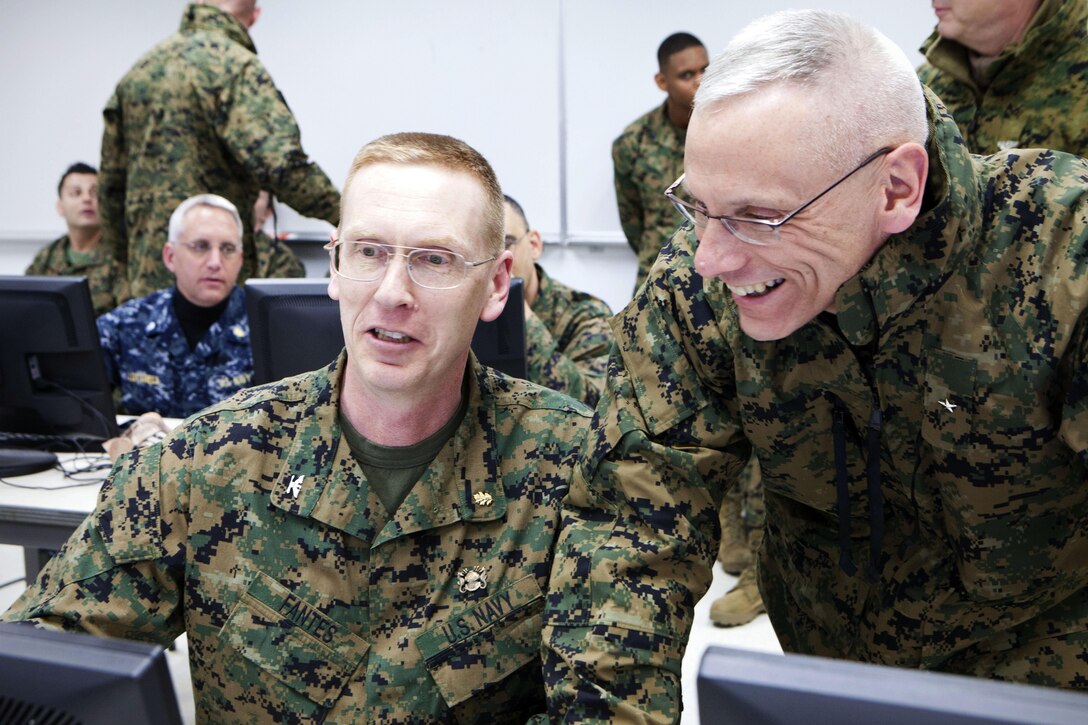 Capt. Tom Fantes, a doctor in 4th Medical Battalion, 4th Marine Logistics Group, demonstrates the Armed Forces Health Longitudinal Technology Application to Brig. Gen. Roger R. Machut, the commanding general of 4th MLG, during a training session here, April 14. AHLTA will be used during Innovative Readiness Training Arctic Care 2013 to help uniformed personnel capture medical records of Alaskan patients and provide a uniform format usable by other medical providers. IRT Arctic Care is a multi-service humanitarian and training program focusing on enhancing the interoperability and capacity of U.S. forces in peacetime support operations, humanitarian assistance and disaster relief. The exercise is primarily a Reserve effort with Marine Forces Reserve taking the lead and receiving logistical and medical support from the National Guard, Army Reserve, Navy Reserve and Air Force Reserve.