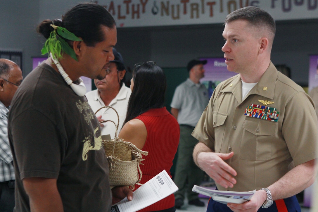 Saipan resident John Castro speaks with Marine Maj. Bryan Swenson, a training and aviation officer, during a public scoping meeting April 10 at the Dandan Elementary School.  Swenson; who is assigned to Headquarters Marine Corps' Plans, Policy and Operations Pacific Division; was one of many subject-matter experts on-hand to provide information, answer questions, and gather comments and concerns from local residents regarding proposed development of live-fire ranges and training areas on Tinian and Pagan islands in CNMI.