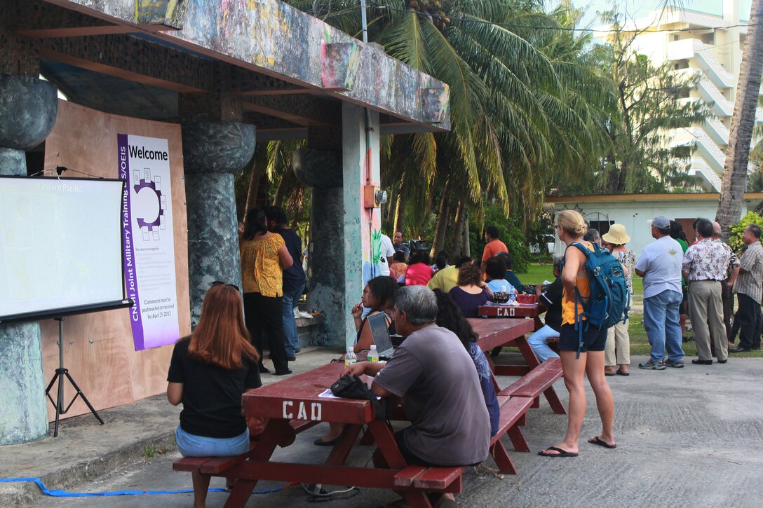 Local residents gather at an outdoor communal beach shelter April 12 for the last in a series of public scoping meetings.  The meetings are part of an ongoing outreach effort with local residents to gather their comments and concerns regarding a proposal to develop live-fire ranges and training areas on Tinian and Pagan islands in CNMI.