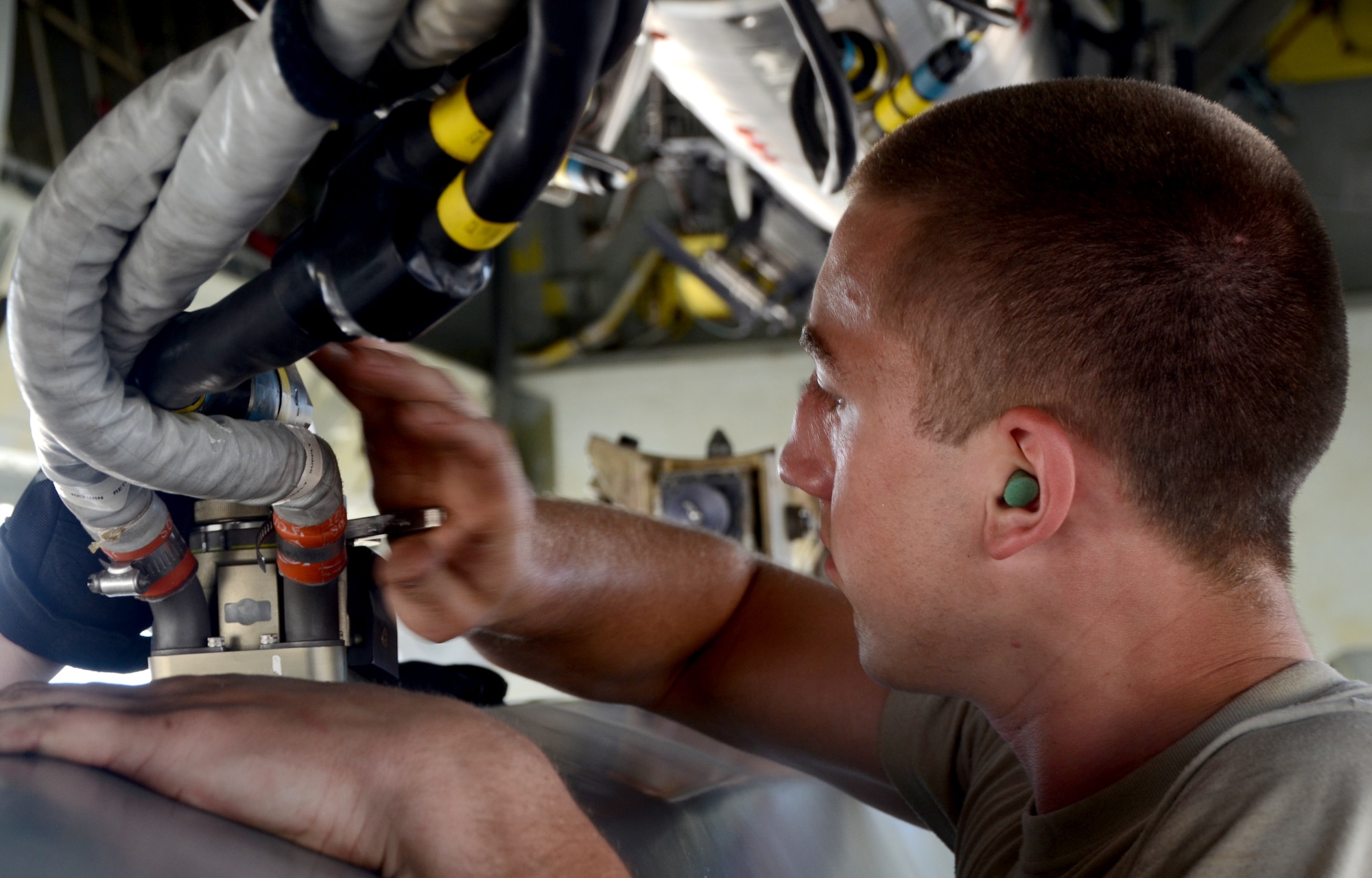 Airman 1st Class Adam Schaetzl, 36th Expeditionary Aircraft Maintenance Squadron weapons load technician, installs an umbilical connector into a training AGM-86C Conventional Air-Launched Cruise Missile during a B-52 Stratofortress load demonstration at Andersen Air Force Base, Guam, April 16, 2013. All EAMUs deployed to Andersen have to pass a load inspection within 10 days of arrival as part of a U.S. Pacific Command requirement to ensure all tools and equipment are mission ready. It is opportunity for maintainers to obtain munitions-loading experience in both a training and tropical environment. (U.S. Air Force photo by Senior Airman Benjamin Wiseman/Released)