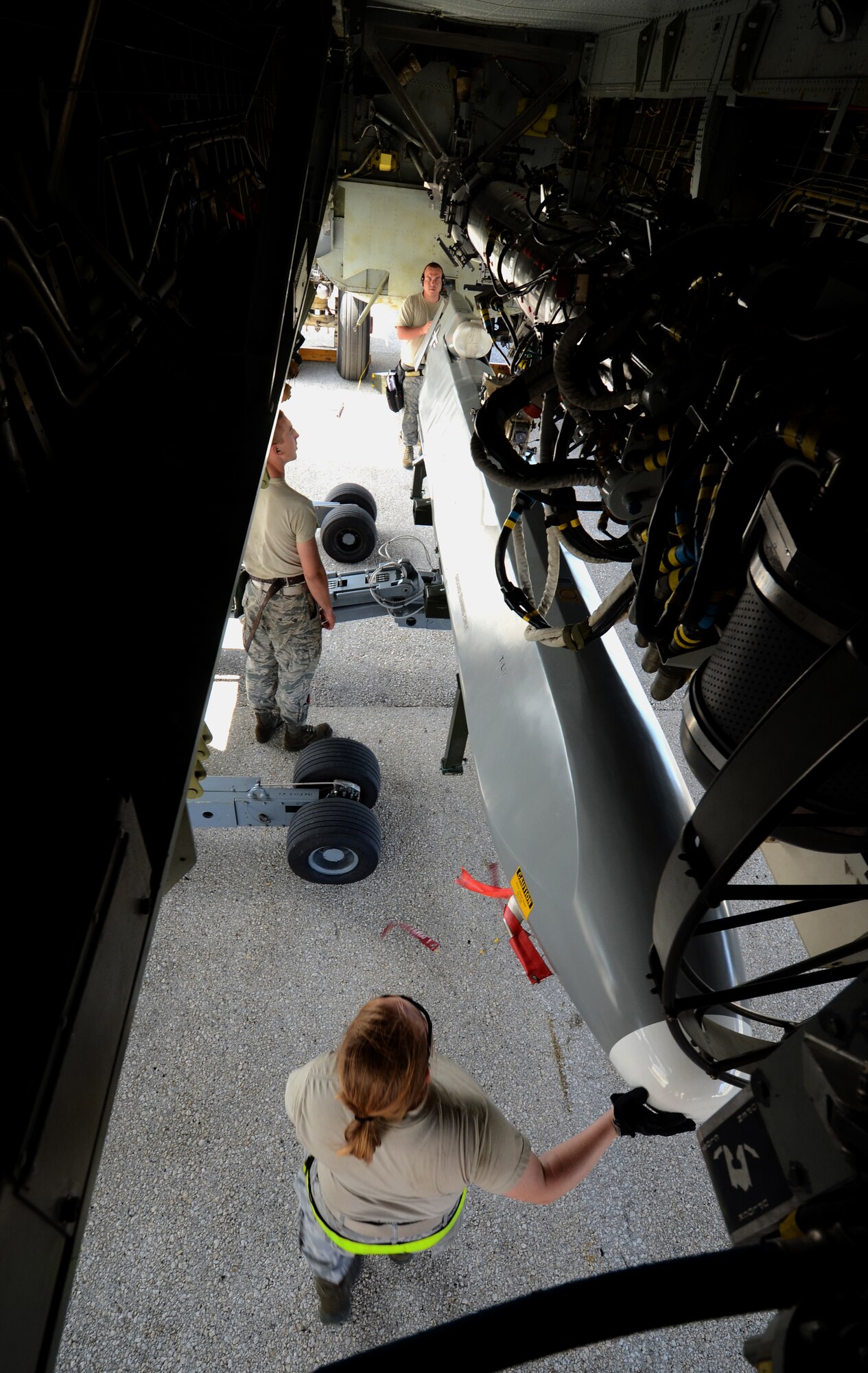 A training AGM-86C Conventional Air-Launched Cruise Missile is loaded to a B-52 Stratofortress by Airmen from the 36th Expeditionary Aircraft Maintenance Squadron, deployed from the 23rd Expeditionary Aircraft Maintenance Unit, Minot Air Force Base, N.D., during a load demonstration at Andersen Air Force Base, Guam, April 16, 2013. All EAMUs deployed to Andersen have to pass a load inspection within 10 days of arrival as part of a U.S. Pacific Command requirement to ensure all tools and equipment are mission ready. It is opportunity for maintainers to obtain munitions-loading experience in both a training and tropical environment. (U.S. Air Force photo by Senior Airman Benjamin Wiseman/Released)