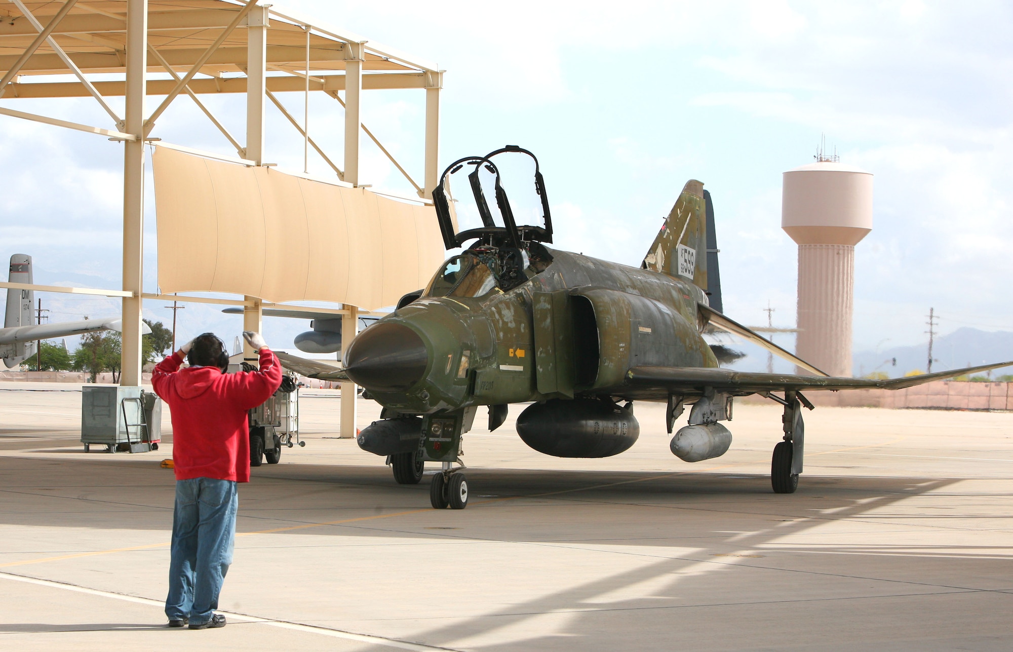 Eddie Caro, crew chief on F-4 Phantom tail number 68-0599, launches the final F-4 delivery to BAE Systems in Mojave, Calif., at Davis-Monthan Air Force Base, Ariz., April 17, 2013. BAE Systems will convert the aircraft into a drone and eventually deliver the jet to Tyndall AFB, Fla. (Courtesy photo/Released)