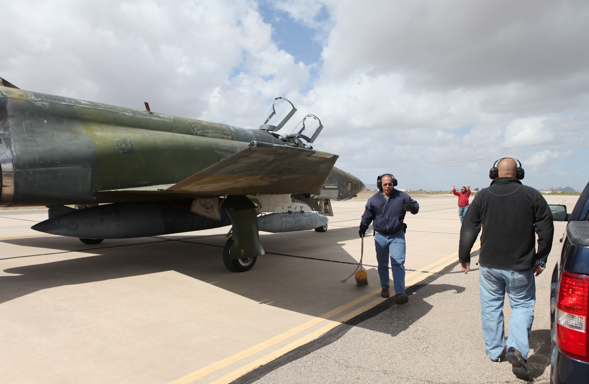 From left, Jose Antrobus, Eddie Caro and Stephen Merz, all assigned to the 576th Aerospace Maintenance and Regeneration Squadron, 309th Aerospace Mainteance and Regeneration Group, perform a last inspection on an F-4 Phantom, tail number 68-0599, at Davis-Monthan Air Force Base, Ariz., April 17, 2013. Caro, crew chief of the aircraft, and the other maintenance professionals put in thousands of hours to return the aircraft to flying status after more than 20 years. (Courtesy photo/Released)