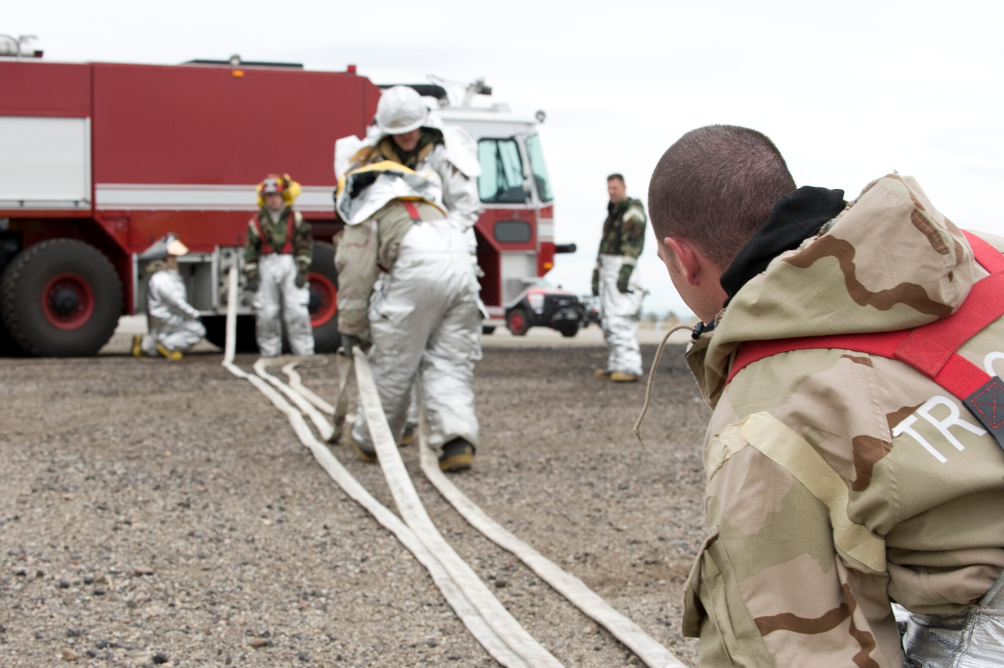 Firefighters put hoses away after a live-fire exercise at Mountain Home Air Force Base, Idaho, April 10, 2013. The firefighters worked together and demonstrated their mission-readiness. (U.S. Air Force Photo/Airman 1st Class Malissa Lott)