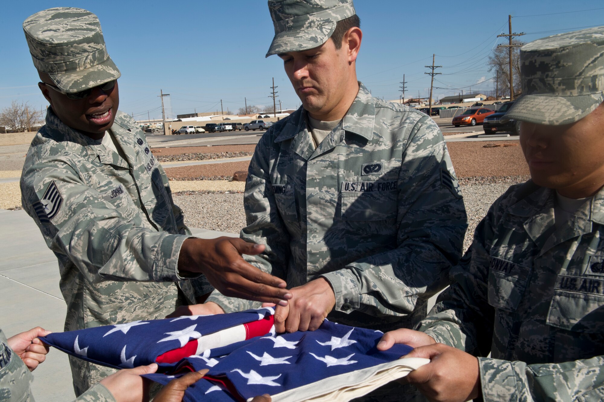 Tech. Sgt. Brad Johnson, Steel Talons Honor Guard NCO in charge, demonstrates the proper way to fold a flag at Heritage Park at Holloman Air Force Base, N.M., Feb. 20. The Holloman honor guard practices every day to perfect the discipline and professionalism necessary to perform under immense pressure during events. (U.S. Air Force photo by Senior Airman Joshua Turner/Released)