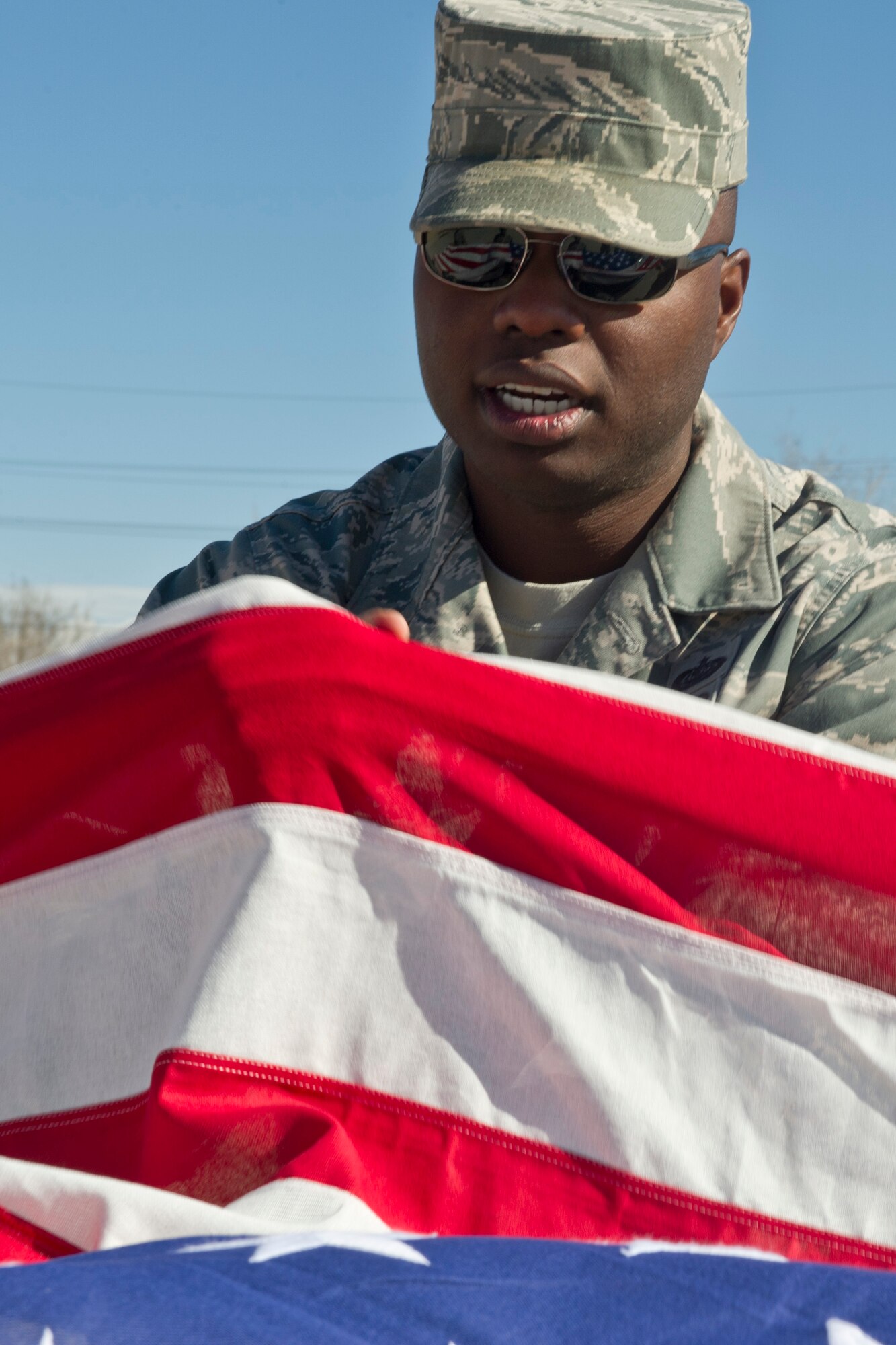 Tech. Sgt. Brad Johnson, Steel Talons Honor Guard NCO in charge, demonstrates the proper way to fold a flag at Heritage Park at Holloman Air Force Base, N.M., Feb. 20. The Holloman honor guard practices every day for more then 300 events a year including military funeral honors, military ceremonies, and community functions. (U.S. Air Force photo by Senior Airman Joshua Turner/Released) 