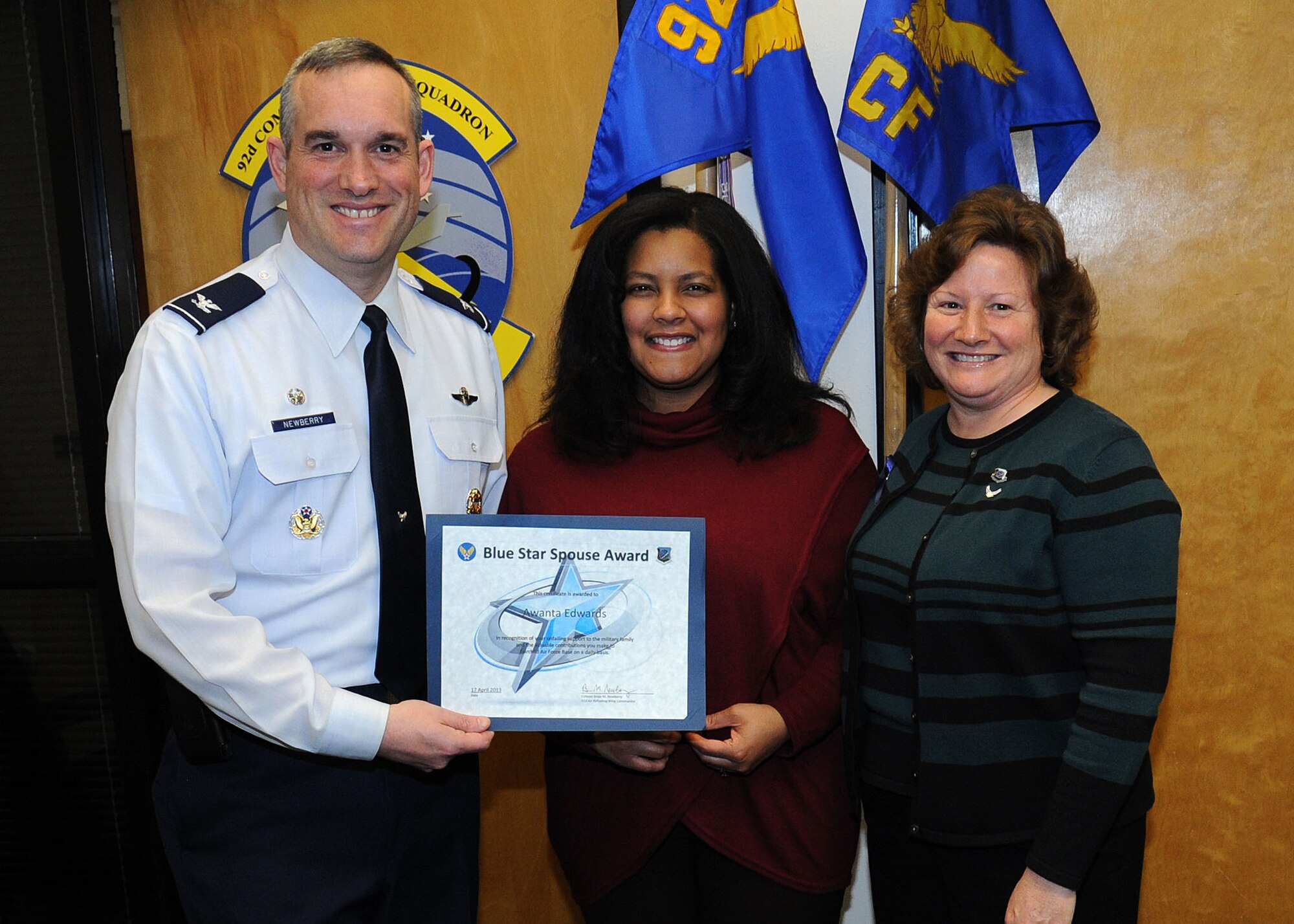 Col. Newberry, 92nd Air Refueling Wing commander, and his wife, Jill, presents the Blue Star Spouse Award to Mrs. Awanta Edwards, April 17, 2013. The award is presented to Fairchild spouses for their commitment to excellence and support to the Fairchild family. Chadwick is an active member of the enlisted spouses club. Anyone interested in nominating someone for the Blue Star Spouse Award should contact their squadron commander. (U.S. Air Force photo by Senior Airman Samantha Krolikowski)