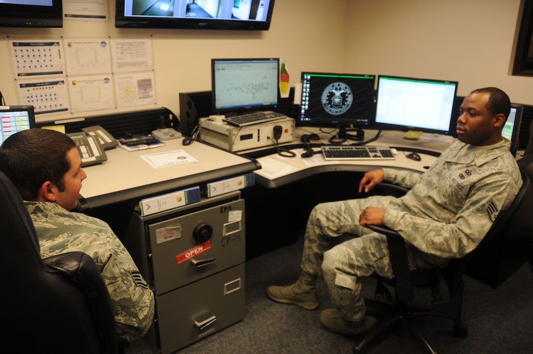 Air Force Staff Sgt. Greg Askew (right), 82nd Training Wing command post controller, talks through a training problem with Staff Sgt. Charles Thompson at Sheppard Air Force Base, Texas, April 18, 2013.  Askew was recently named the 2012 Air Education and Training Command NCO of the Year for the command post career field. (U.S. Air Force photo/Dan Hawkins) 