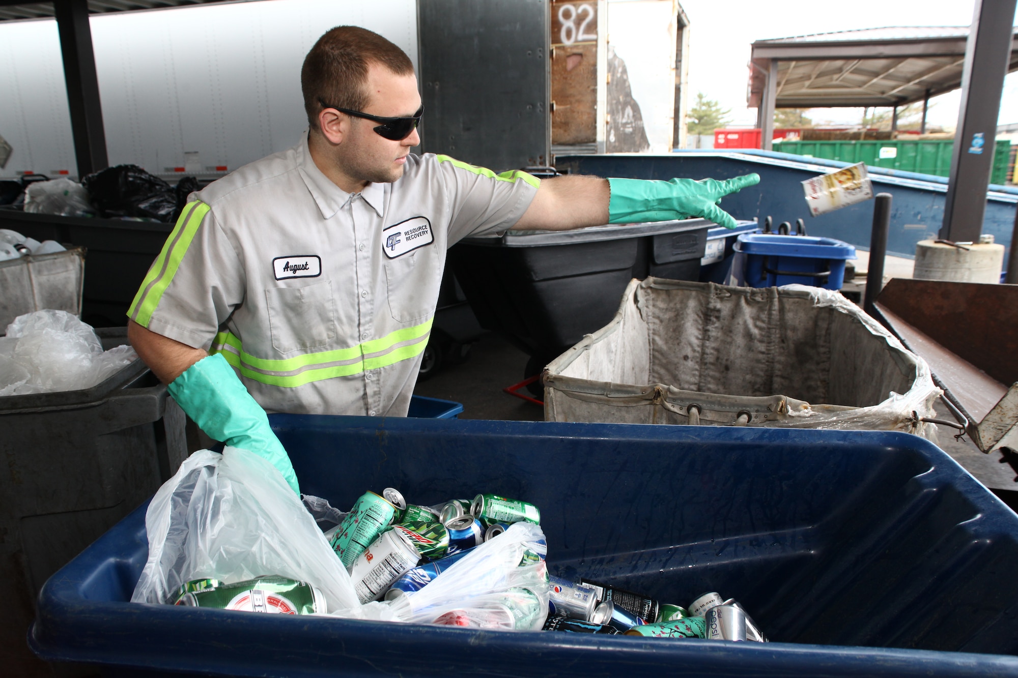 August Randall, Joint Base McGuire-Dix-Lakehurst Recycle Center recycling specialist, separates  glass, plastic and aluminum recyclables into separate bins April 15, 2013, at JB MBL, N.J. All waste that is collected from throughout JB MDL is brought back to the recycling center where it is separated and sent for further recycling. This ensures that it is diverted from landfill. (U.S. Air Force photo by Wayne Russell/Released)