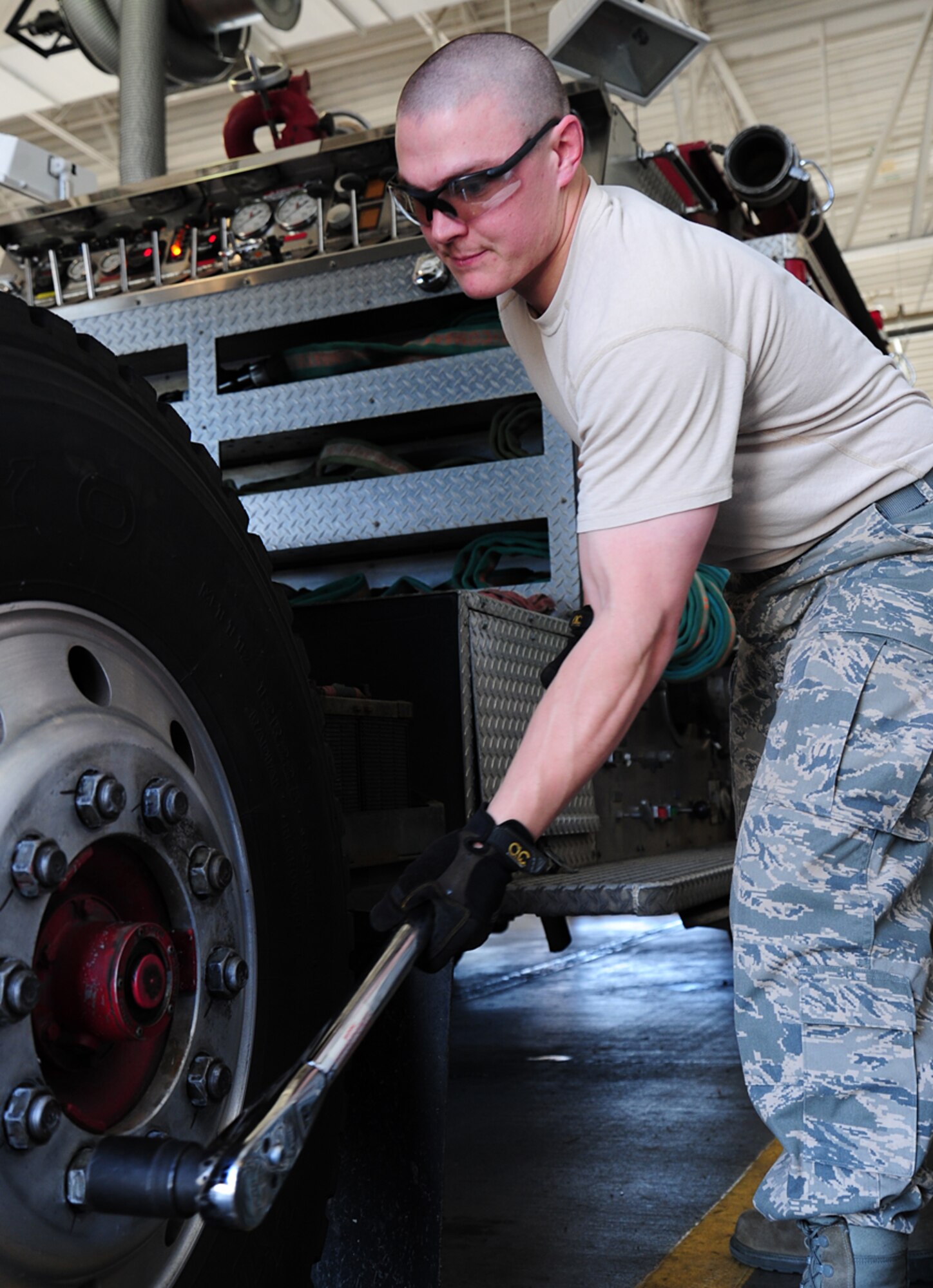 Staff Sgt. William Colley, 92nd Logistics Readiness Squadron NCO in charge of fire truck maintenance, tightens a  lognut on a tire of a P-22 fire truck at Fairchild Air Force Base, Wash., April 17, 2013. Colley has been selected as a member of Fairchild’s Finest. (U.S. Air Force photo by Airman 1st Class Janelle Patiño)