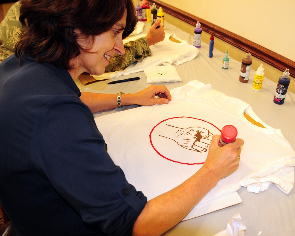 Ms. Patty Braun, 914th Airlift Wing Executive Officer designs a T-shirt during a Clothesline Project Event at the Niagara Falls Air Reserve Station on April 18, 2013. This national annual event encouraged base personnel and their dependants to decorate T-shirts or a pair of jeans with a message demonstrating their pledge to bring an end to Sexual Assault and Domestic Violence. (U.S. Air Force photo by Peter Borys)