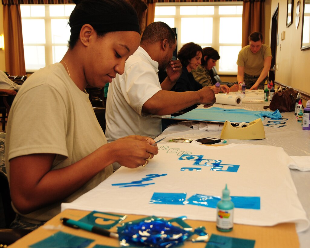 2nd Lt. Keisha Dobney-Boykin, 914th Force Support Squadron Personnel Officer designs a T-shirt during a Clothesline Project Event at the Niagara Falls Air Reserve Station on April 18, 2013. This national annual event encouraged base personnel and their dependants to decorate T-shirts or a pair of jeans with a message demonstrating their pledge to bring an end to Sexual Assault and Domestic Violence. (U.S. Air Force photo by Peter Borys)