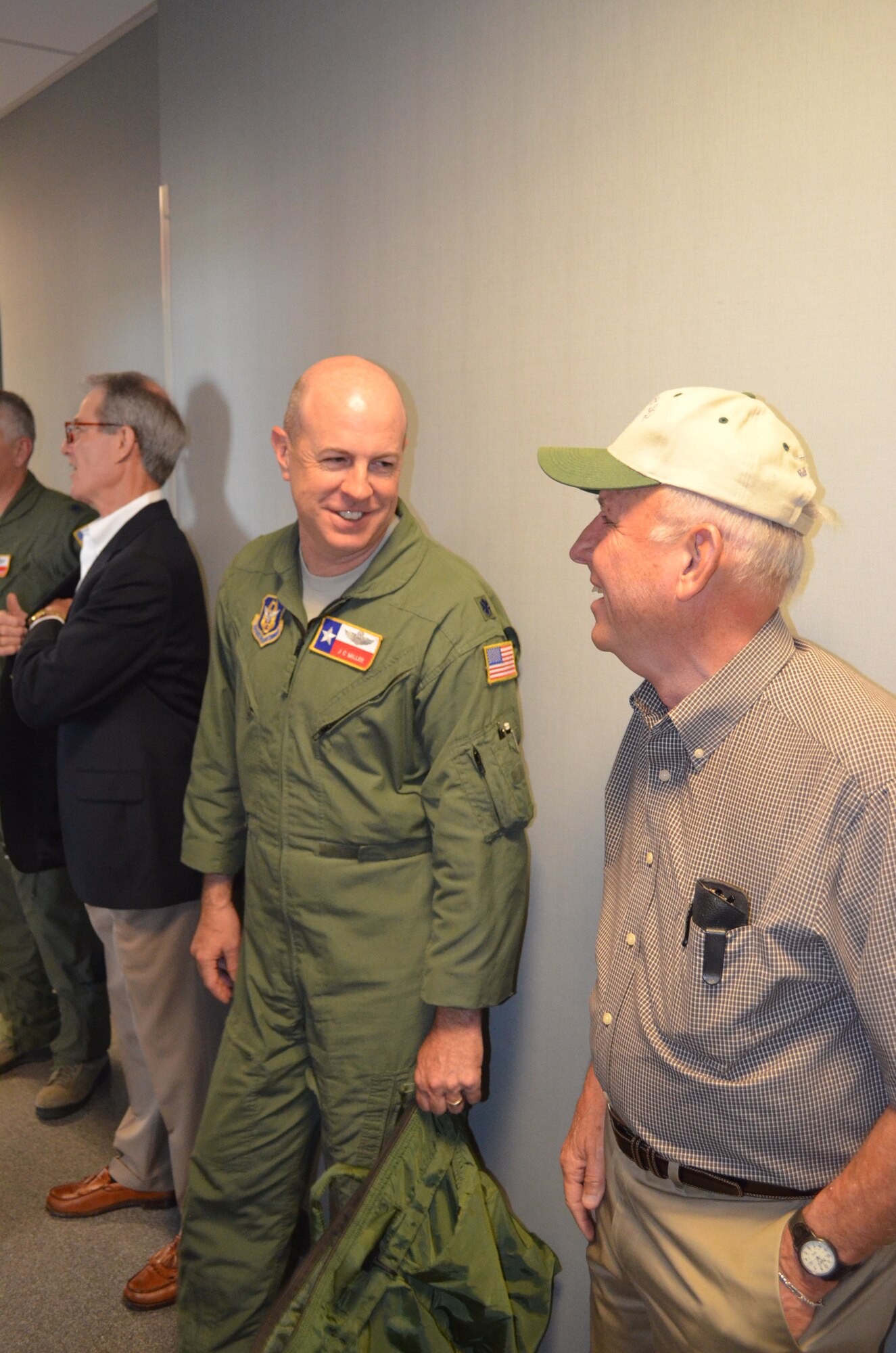 Retired Col. Gary Spence, a former 433rd Operations Group commander, chats with Lt. Col. J.C. Miller, 68th Airlift Squadron operations officer, during a luncheon for former "Alamo Wing" flyers on April 16. The informal group, which meets every third Tuesday, held their most recent meeting at a luncheon hosted by 433rd Airlift Wing senior leadership. (U.S. Air Force Photo/Maj. Tim Wade)