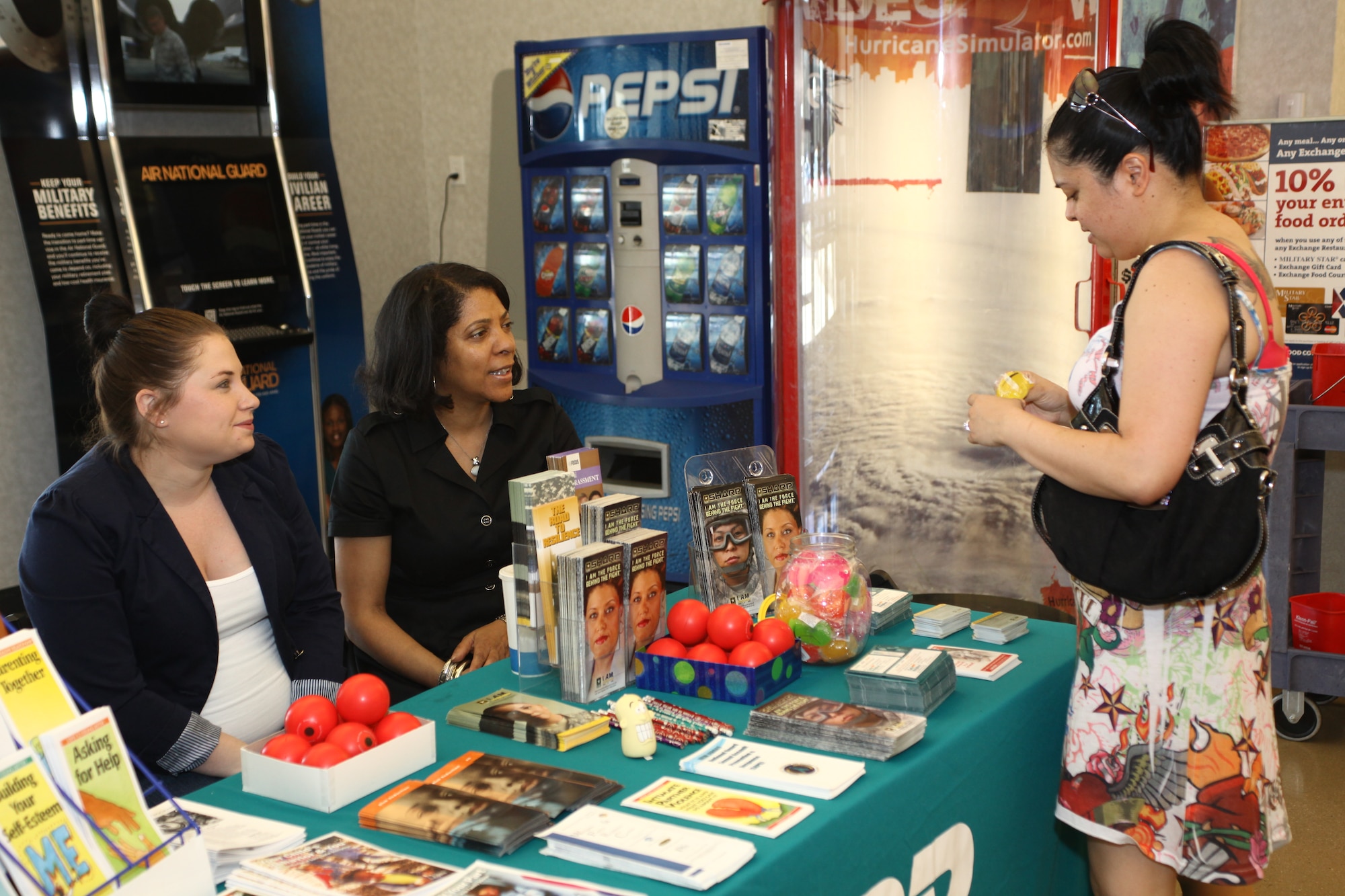 Amanda Brown and Roxanne McElroy, Army Support Activity Dix installation victim sexual assault advocates, talk with Kristina Shepard, wife of Senior Airman Lucas Shepard, 305th Maintenance Squadron crew chief, about the sexual assault awareness and prevention in the Mall area of the Base Exchange during Sexual Assault month April 10, 2013, at Joint Base McGuire-Dix-Lakehurst, N.J. The display table is manned by sexual assault response coordinators who work for the Air Force and the 87th Air Base Wing and installation victim sexual assault advocates for ASA-Dix. (U.S. Air Force photo by Wayne Russell/Released) 