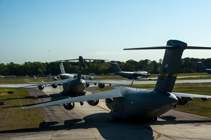 C-17 Globemaster IIIs taxi towards the runway for takeoff during a training exercise April 10, 2013, at Joint Base Charleston – Air Base, S.C. Thirteen C-17s participated in the exercise which included airdrops, aerial refueling and low-level tactical training. The exercise is a total-force effort with aircrews consisting of active-duty Airmen from the 437th Airlift Wing and 315th AW, and completed over 600 training requirements in a single day. (U.S. Air Force photo/ Senior Airman George Goslin)