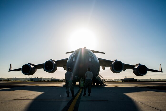 Senior Airman Edward Bachelor (right) and Senior Airman Michael Bowker (left), 437th Aircraft Maintenance Squadron crew chiefs, prepare to perform preflight checks on a C-17 Globemaster III during a training exercise April 10, 2013, at Joint Base Charleston – Air Base, S.C. Thirteen C-17s participated in the exercise which included airdrops, aerial refueling and low-level tactical training. The exercise is a total-force effort with aircrews consisting of active-duty Airmen from the 437th Airlift Wing and 315th AW, and completed over 600 training requirements in a single day. (U.S. Air Force photo/ Senior Airman George Goslin)