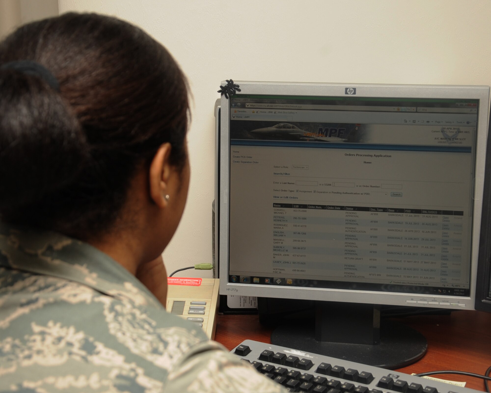 Airman 1st Class Marche Wesley, 2nd Force Support Squadron career development, looks through virtual records at the military personnel section on Barksdale Air Force Base, La., April 18, 2013. The MPS consists of customer service, awards and decorations, passports, personnel assistance management, information desk and client support administrators. (U.S. Air Force photo/Senior Airman Sean Martin)