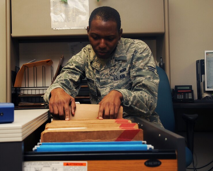 Senior Airman Larry Washington, 2nd Force Support Squadron career development, looks for a customer's folder at the military personnel section on Barksdale Air Force Base, La., April 18, 2013. Airmen from the MPS assist base personnel who are out-processing by directing them through the various steps of the process. The MPS is open from 7:30 a.m. to 4:30 p.m. Monday through Friday. (U.S. Air Force photo/Senior Airman Sean Martin)