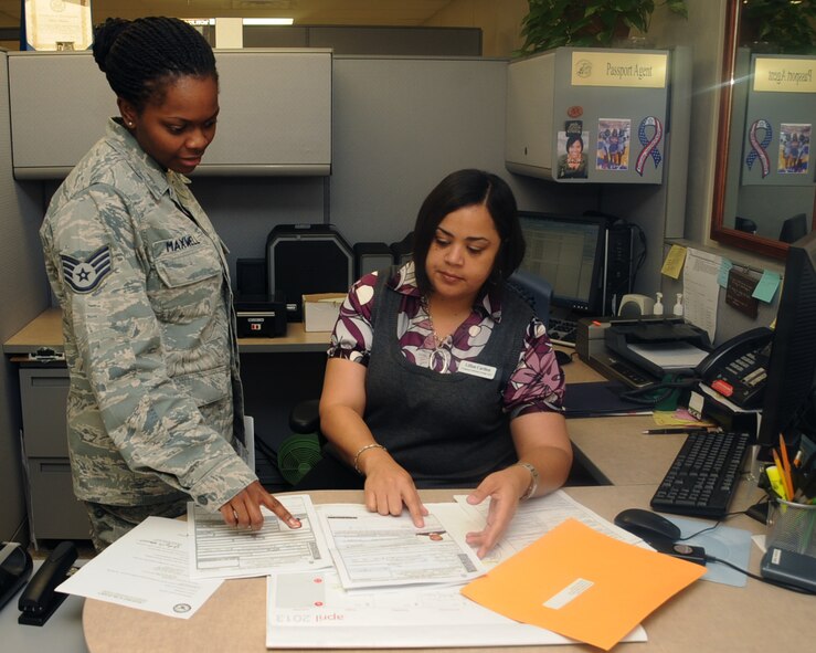 Staff Sgt. Keonda Maxwell, 2nd Force Support Squadron passport agent, goes over an individual's passport application with Lillian Carthen, 2 FSS passport administrator on Barksdale Air Force Base, La., April 18, 2013. The passport office handles all official passports and VISAs for active duty and civilians. (U.S. Air Force photo/Senior Airman Sean Martin)