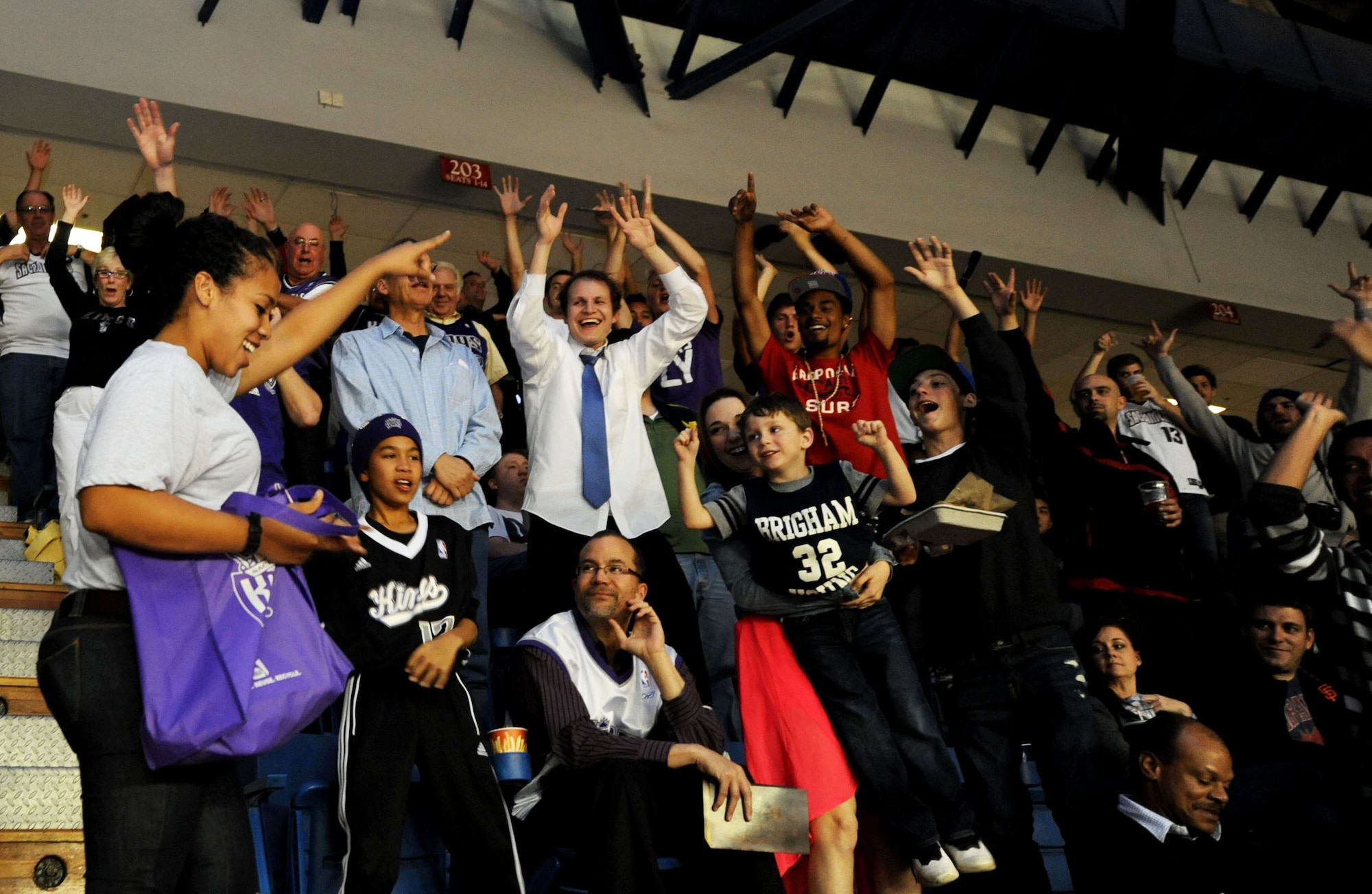 Airman 1st Class Brittany Jackson (left), 9th Operations Support Squadron air traffic controller, excites fans as she passes out prizes at the Sleep Train Arena during the Sacramento Kings vs. L.A. Clippers game April 17, 2013. Jackson and other Beale Airmen volunteered to aid the Kings’ staff during fan appreciation night. (U.S. Air Force photo by Airman 1st Class Bobby Cummings/Released)