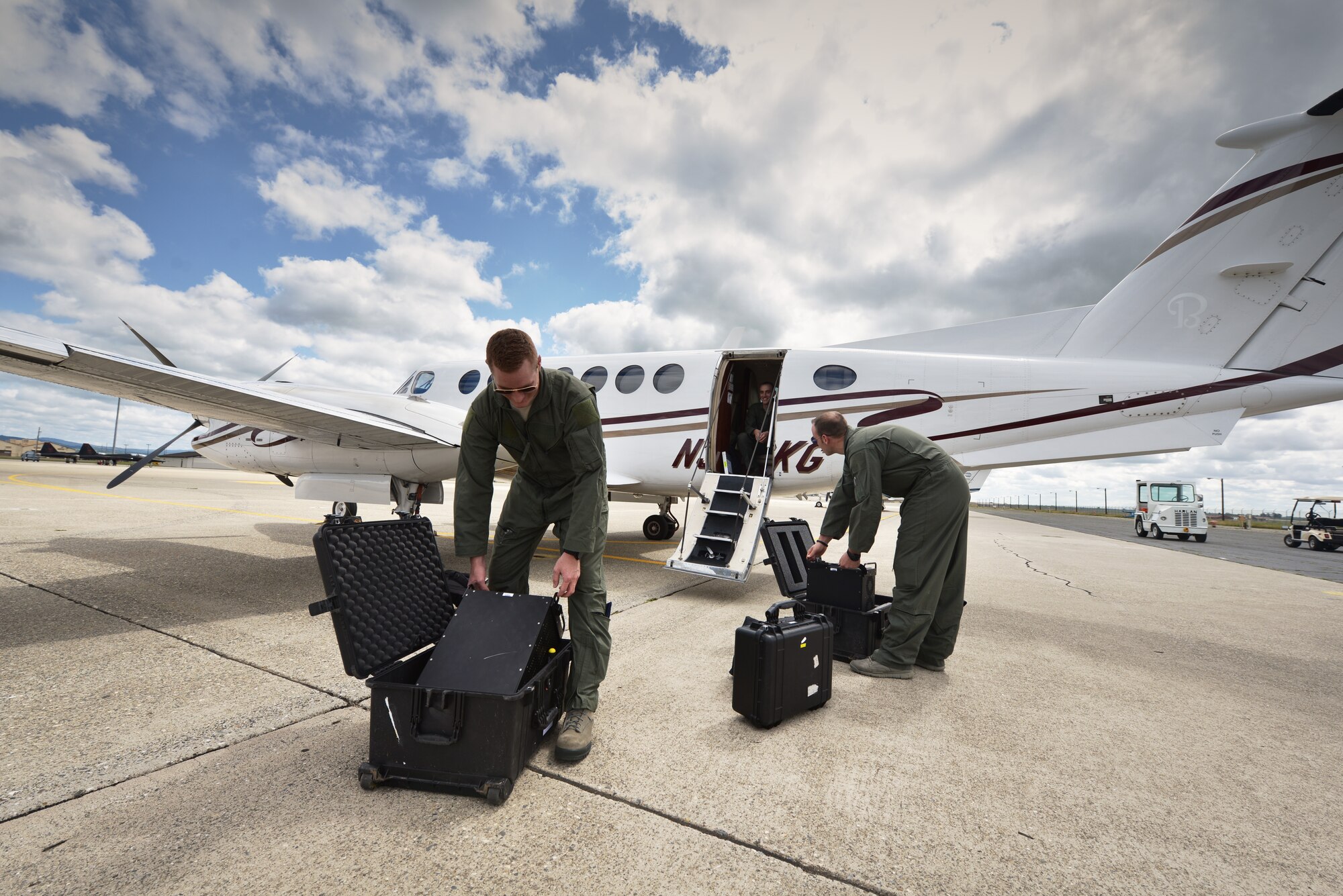 Tactical systems operator students assigned to the 306th Intelligence Squadron load specialized air-to-ground radio equipment onto a C-12 King Air aircraft in preparation for a training sortie at Beale Air Force Base, Calif., April 5, 2013. The King Air aircraft are leased by the U.S. Air Force to provide initial quality training equipment for airborne tactical systems operators. (U.S. Air Force photo by Airman 1st Class Drew Buchanan/Released)