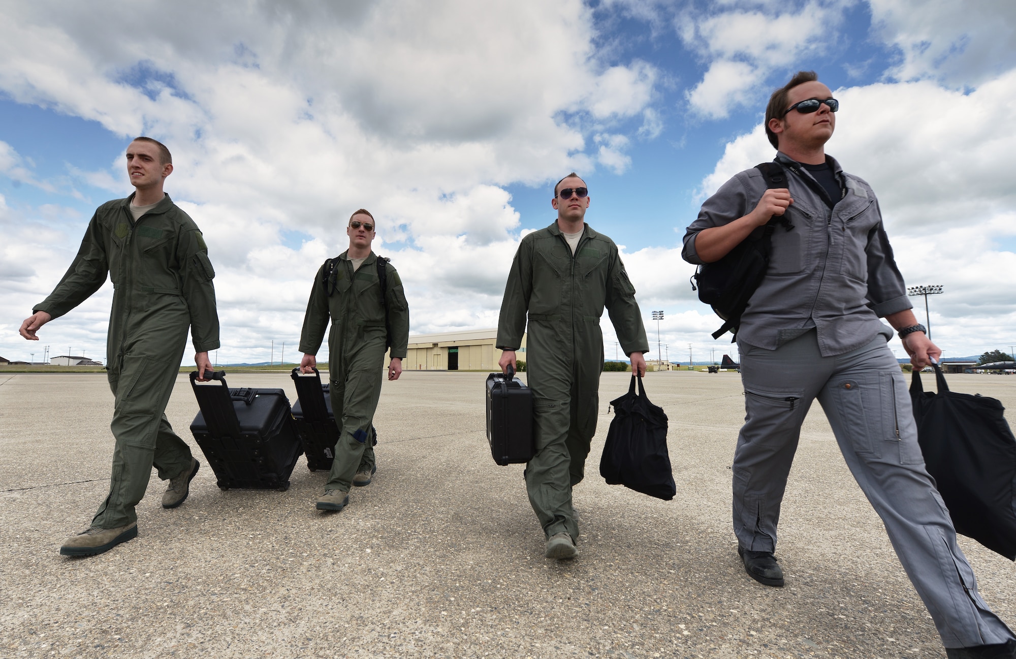 Tactical systems operators and students assigned to the 306th Intelligence Squadron walk out to a C-12 King Air aircraft in preparation for a training sortie at Beale Air Force Base, Calif., April 5, 2013. (U.S. Air Force photo by Airman 1st Class Drew Buchanan/Released)