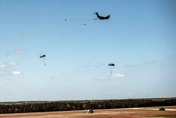 A C-17 Globemaster III performs an aerial drop over North Auxiliary Airfield during an exercise April 10, 2013, at Joint Base Charleston – Air Base, S.C. Thirteen C-17s participated in the exercise which included airdrops, aerial refueling and low-level tactical training. The exercise is a total-force effort with aircrews consisting of active-duty Airmen from the 437th Airlift Wing and 315th AW, and completed over 600 training requirements in a single day.  (U.S. Air Force photo/ Senior Airman Dennis Sloan)