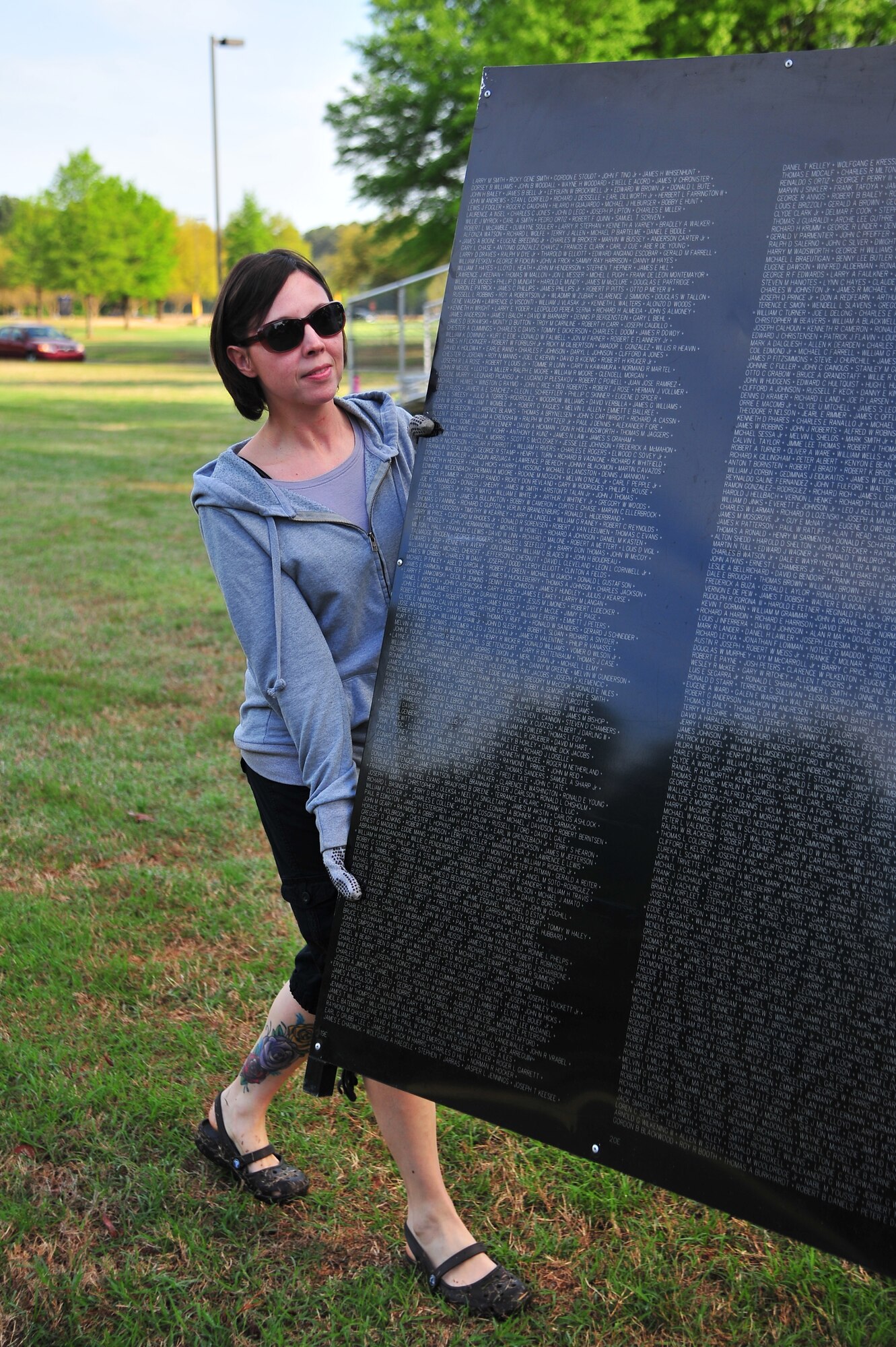 U.S. Air Force Tech. Sgt. Colette Graham, 4th Fighter Wing Public Affairs NCO in charge of operations, helps carry a piece of the Vietnam Veterans Memorial Traveling Wall at the Wayne Community College campus in Goldsboro, N.C., April 17, 2013. Several members of Team Seymour and the local community came together to assemble the wall, honoring more than 58,000 fallen Vietnam War veterans. (U.S. Air Force photo by Airman 1st Class Aubrey White/Released)