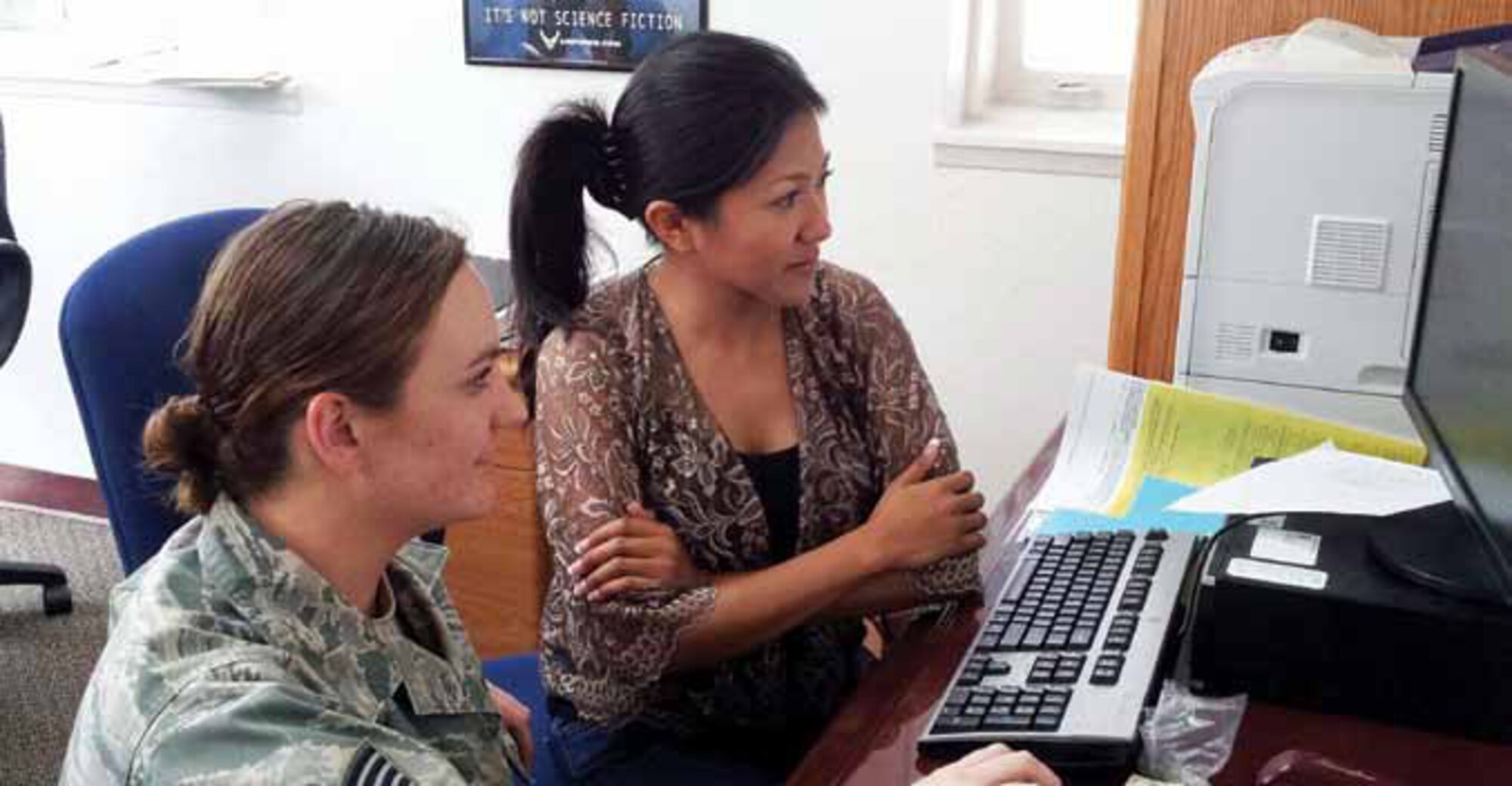 Staff Sgt. Sara Luna, 912th Air Refueling Squadron, works with Theeraya Kline, volunteer spouse, at the March Air Reserve Base Volunteer Income Tax Assistance tax center. The all-volunteer staff at the March VITA tax center prepared and filed more than 820 federal and state tax returns for Tax Year 2012, for members of the March community, free of charge. (U.S. Air Force photo by Maj. Deric Prescott)