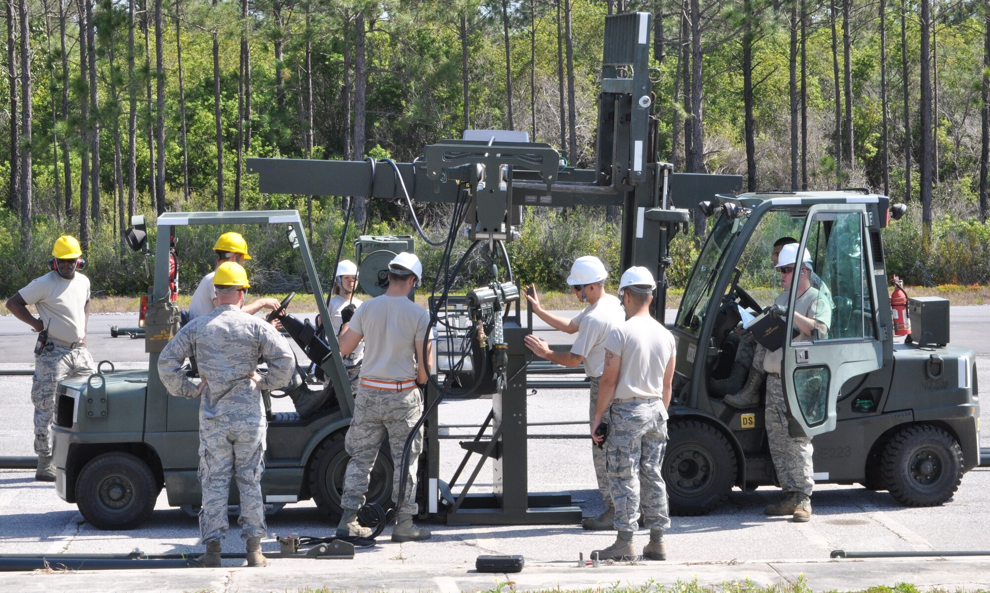 Members of the 325th Maintenance Squadron build the Munitions Assembly Conveyor II for the first time on April 10 in the Alert Facility parking lot on Tyndall Air Force Base. The MAC II is a system that acts as an assembly line for munitions and speeds up the process of their build. (U.S. Air Force photo by Airman 1st Class Alex Echols)