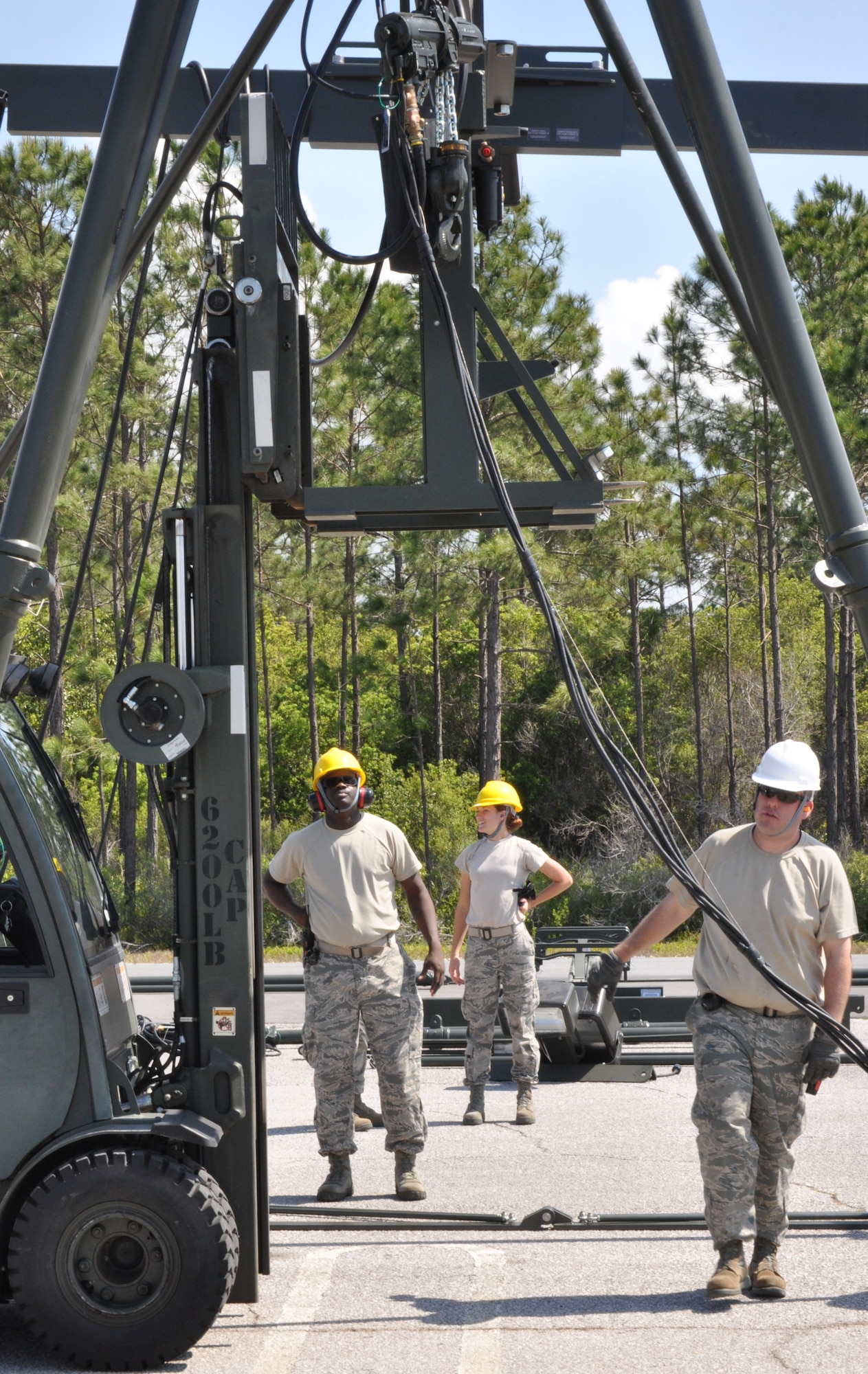 Members of the 325th Maintenance Squadron build the Munitions Assembly Conveyor II for the first time on April 10 in the Alert Facility parking lot on Tyndall Air Force Base. The MAC II is a system that acts as an assembly line for munitions and speeds up the process of their build. (U.S. Air Force photo by Airman 1st Class Alex Echols)