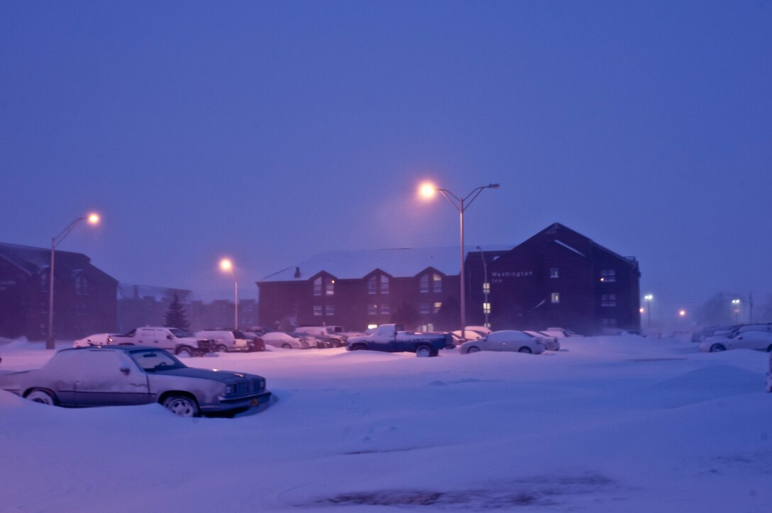 Vehicles covered in snow sit in a dormitory parking lot at Ellsworth Air force Base, S.D., April 10, 2013. T wenty-one inches of snow covered the roads and made traveling hazardous on base. For current road conditions call (605) 385-ROAD (7623). (U.S. Air Force photo by Airman 1st Class Zachary Hada/Released)