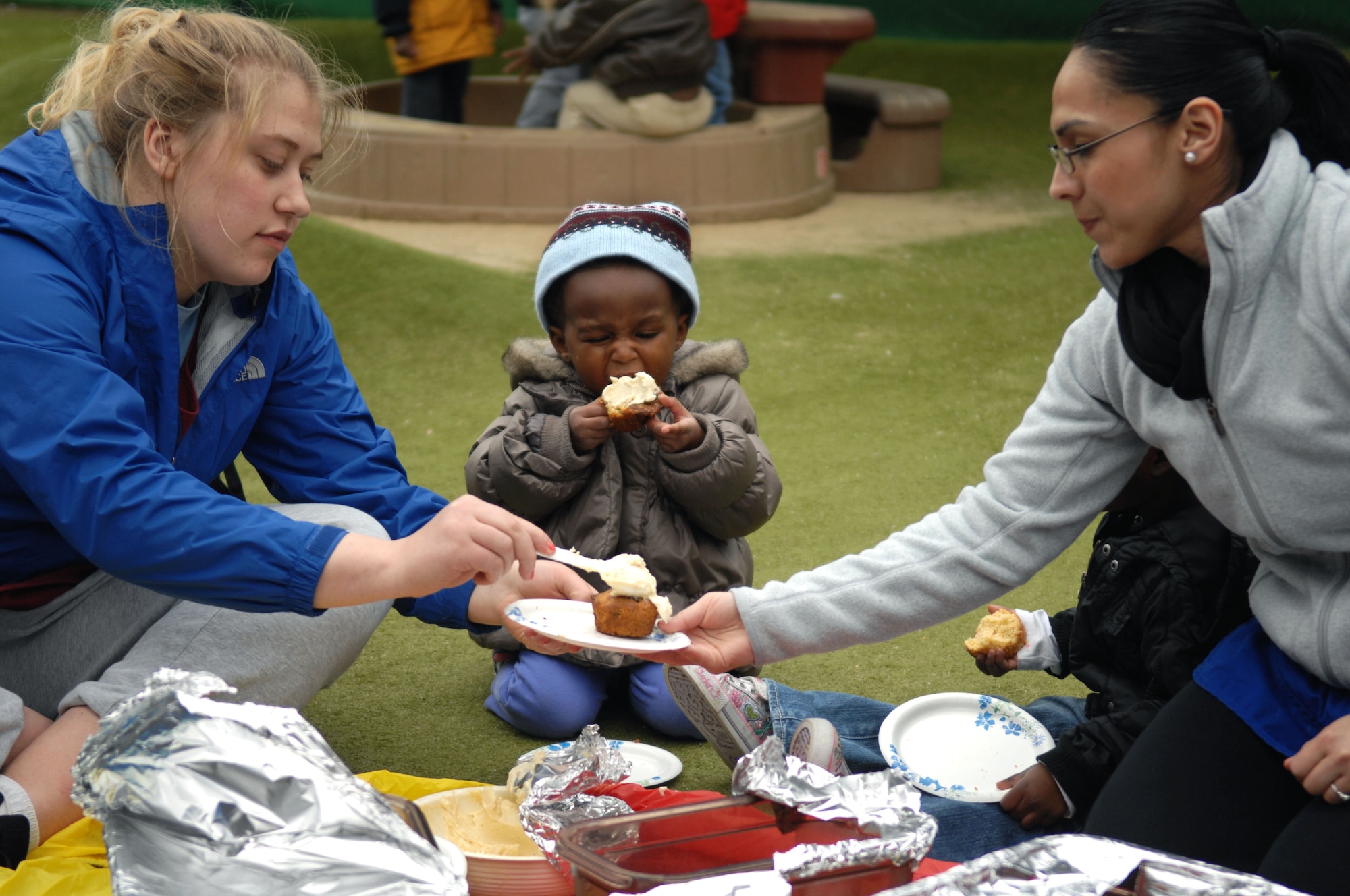 Jacquelin Sample, 2, daughter of Staff Sgt. Celeste Sample, 48th Surgical Operations Squadron obstetrics and gynecology medical technician, eats a cupcake during a snack picnic April 17, 2013, at the Child Development Center on RAF Mildenhall, England. Children helped prepare snacks for their parents during the event. (U.S. Air Force photo by Airman 1st Class Dillon Johnston/Released)