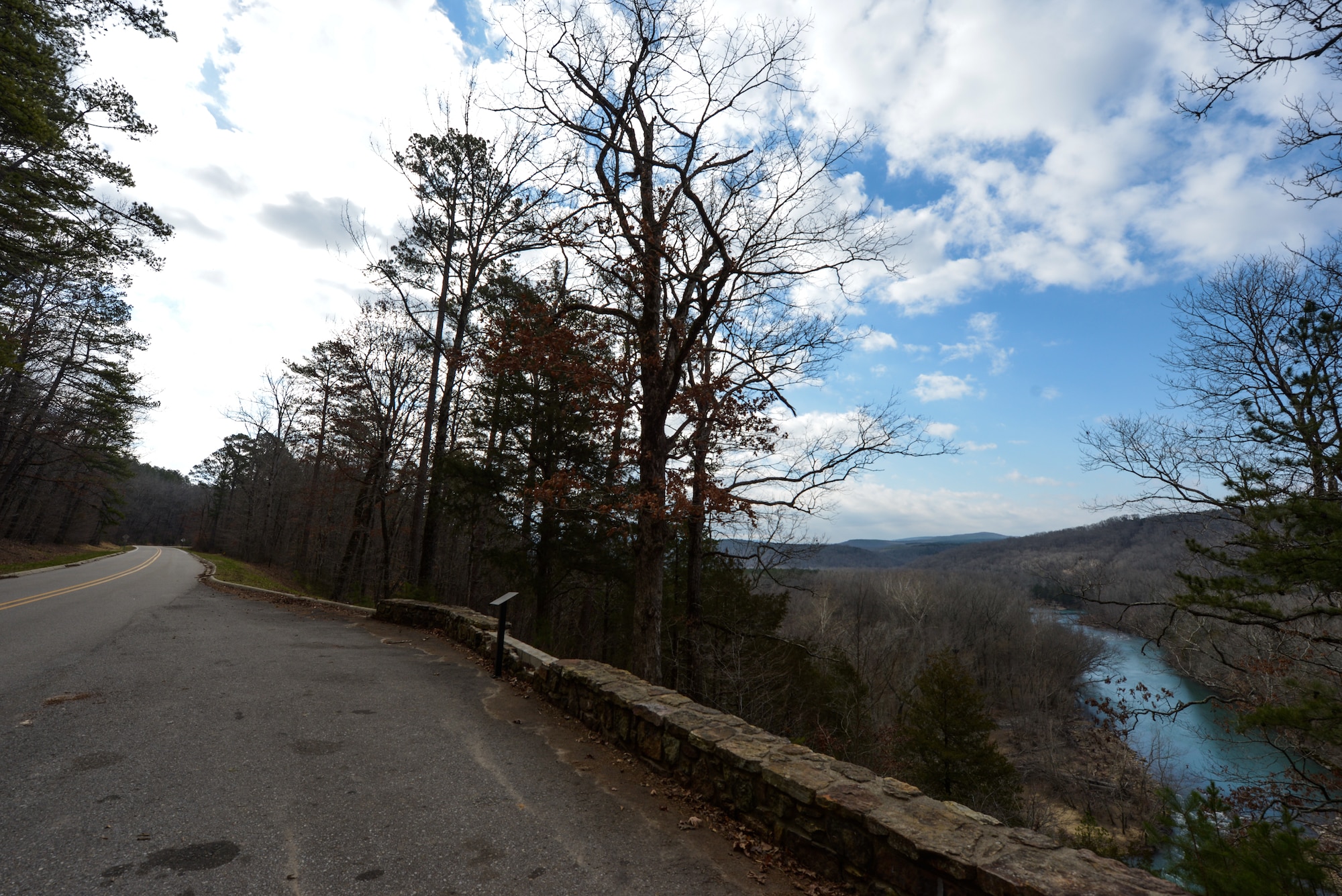 The Ozark National Forest offers winding roads and breathtaking vistas. Arkansas Highway 215 is one of many roads in the region that follow both mountainous terrain and flowing streams.