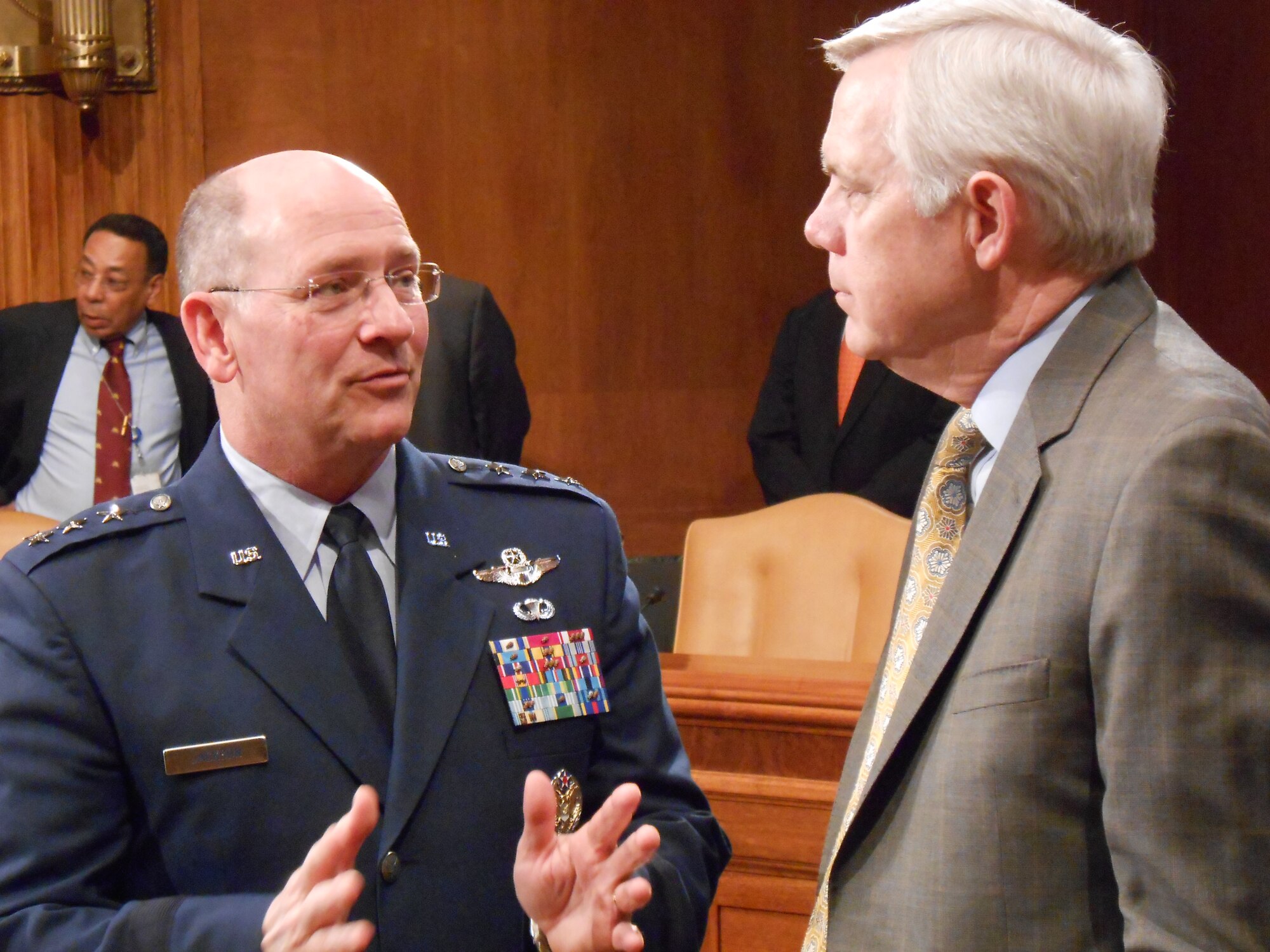 Lt. Gen. James F. Jackson (left) discusses the proposed fiscal 2014 budget of the Air Force Reserve with retired Air Force Maj. Gen. Tom Carter April 17, 2013, on Capitol Hill in Washington, D.C. The top leaders from Army, Navy, Marine and Air Force Reserve and National Guard programs provided statements and answered questions regarding the estimates for next year's funding at the U.S. Senate Committee on Appropriations Subcommittee on Defense. (U.S. Air Force photo/Col. Bob Thompson)