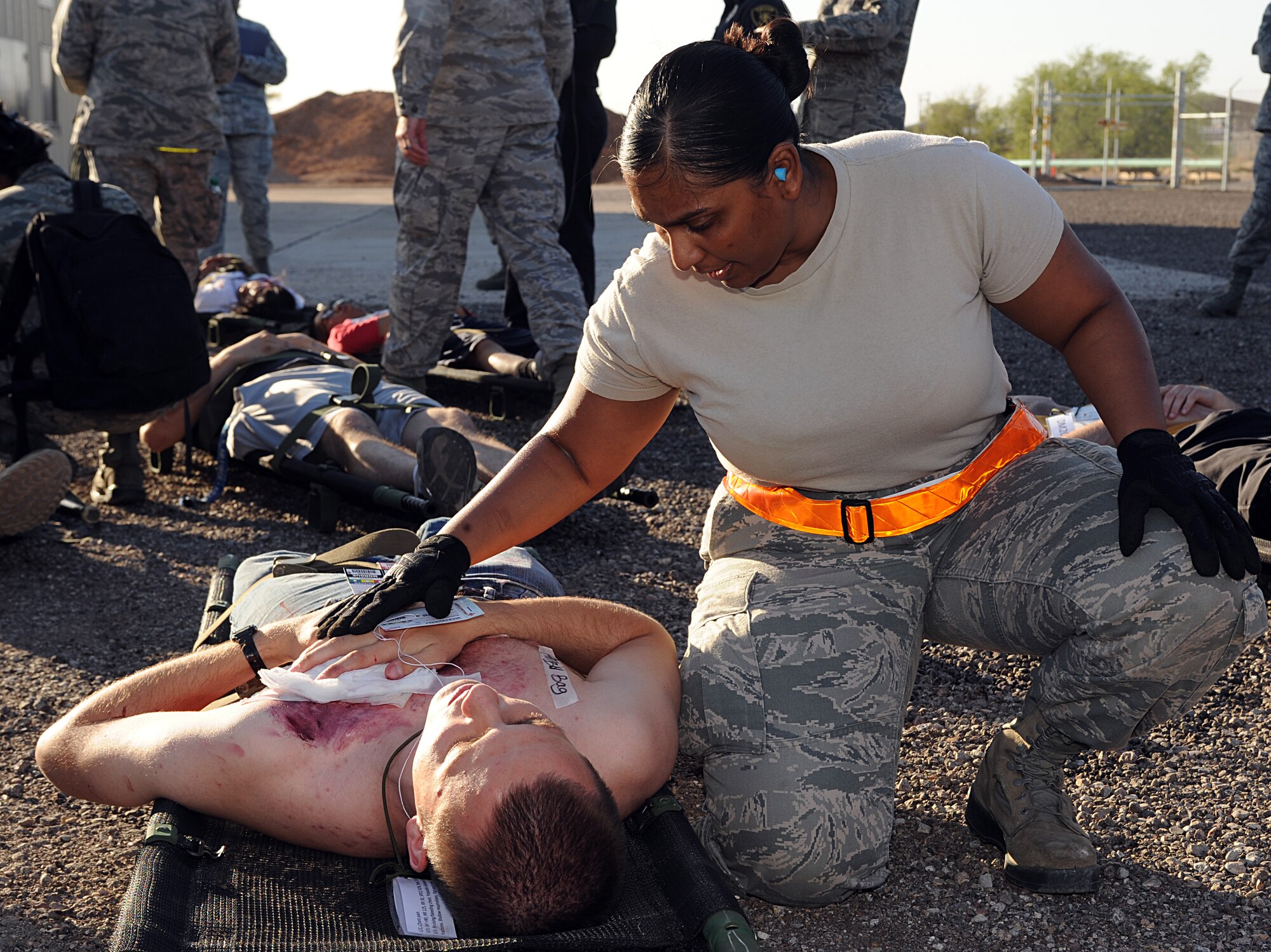 U.S. Air Force Senior Airman Sharla Iseah, 355th Dental Squadron, talks to a victim of a simulated aircraft crash during an emergency medical exercise of Angel Thunder at Davis-Monthan Air Force Base, Ariz., April 13, 2013. Each victim that was transported by Tucson emergency medical responders was attended by D-M medical personnel until they were simulated to be picked up. (U.S. Air Force photo by Senior Airman Timothy Moore/Released)