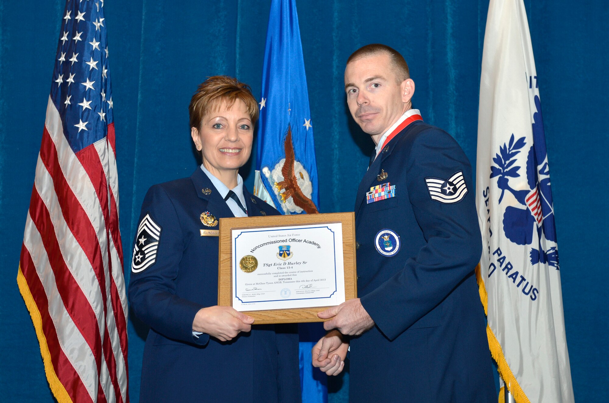 McGHEE TYSON AIR NATIONAL GUARD BASE, Tenn. - Tech. Sgt. Eric D. Hurley, Sr., right, receives the distinguished graduate award for NCO Academy Class 13-4 at the I.G. Brown Training and Education Center here from Chief Master Sgt. Denise Jellinski-Hall, Command Chief Master Sergeant of the Air National Guard, here, April 4, 2013.  The distinguished graduate award is presented to students in the top 10 percent of the class.  It is based on objective and performance evaluations, demonstrated leadership, and performance as a team player. (National Guard photo by Master Sgt. Kurt Skoglund/Released)