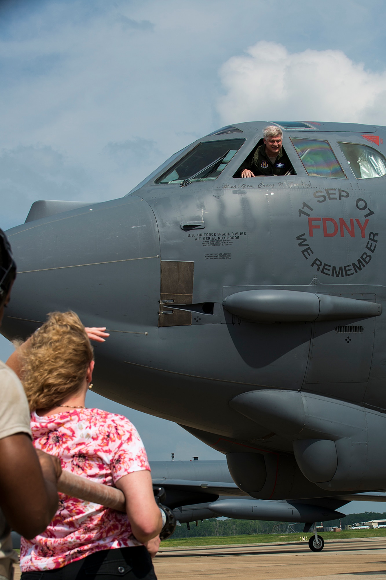 U.S. Air Force Lt. Col. Rick Holt looks out of the window of a B-52H Stratofortress as his wife, Jennifer, waits to hose him down, April 16, 2013, Barksdale Air Force Base, La. Holt has over 5,400 flying hours in the B-52 and retiring after 28 years of service. (U.S. Air Force photo by Master Sgt. Greg Steele/Released)