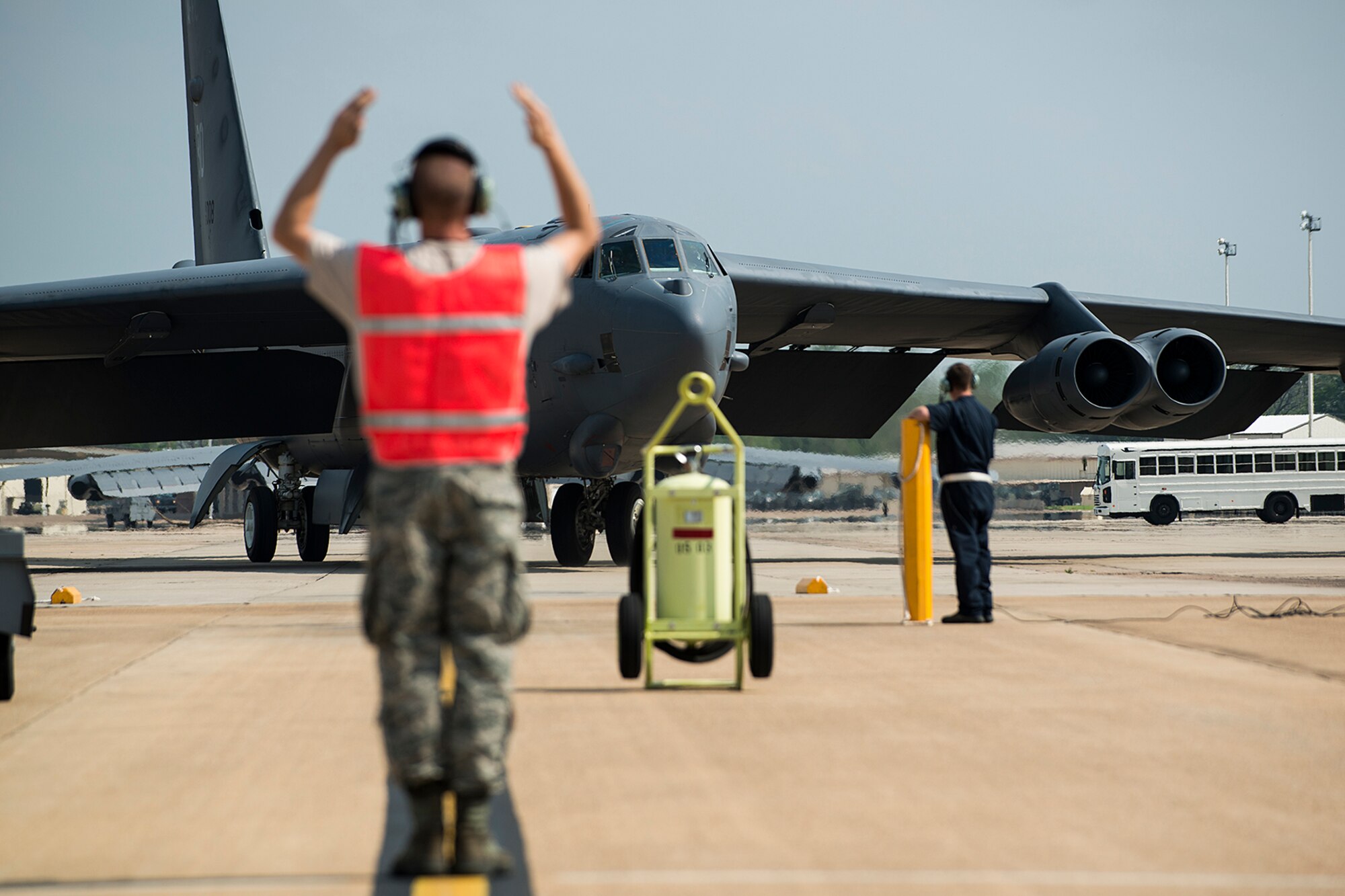 A crewchief marshals a 93rd Bomb Squadron B-52H Stratofortress back to its parking spot after returning from a sortie, April 16, 2013, Barksdale Air Force Base, La. Aboard this aircraft is U.S. Air Force Lt. Col. Rick Holt, who will be retiring from the Air Force Reserve, and this is his last sortie in a B-52. (U.S. Air Force photo by Master Sgt. Greg Steele/Released)
