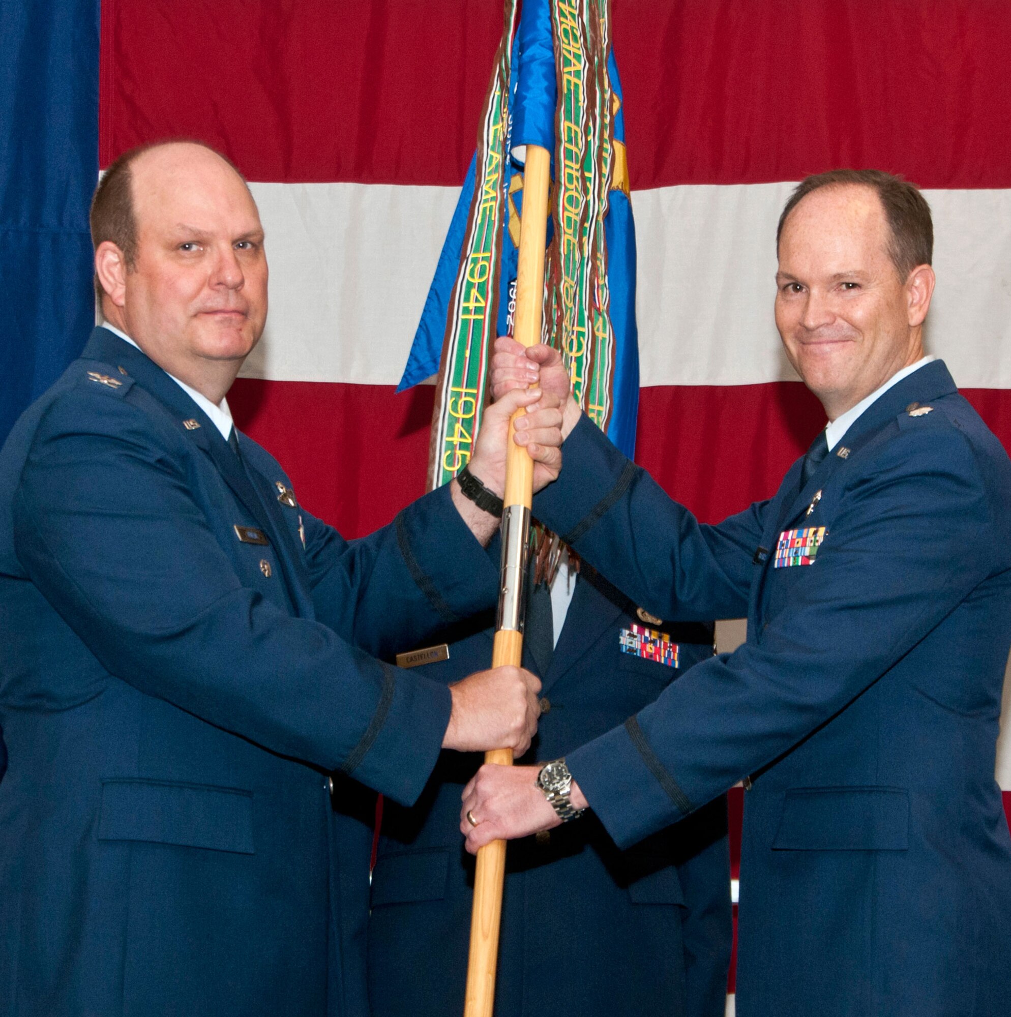 Lt. Col. Phillip Marshall, right, accepts command of the 5th Flying Training Squadron as Col. Dwain Kuehl, assistant director of operations with the 340th Flying Training Group, passes the unit guidon to him during a ceremony held April 16 at the Collocated Club at Vance Air Force Base, Texas. (U.S. Air Force photo/ Terry Wasson)