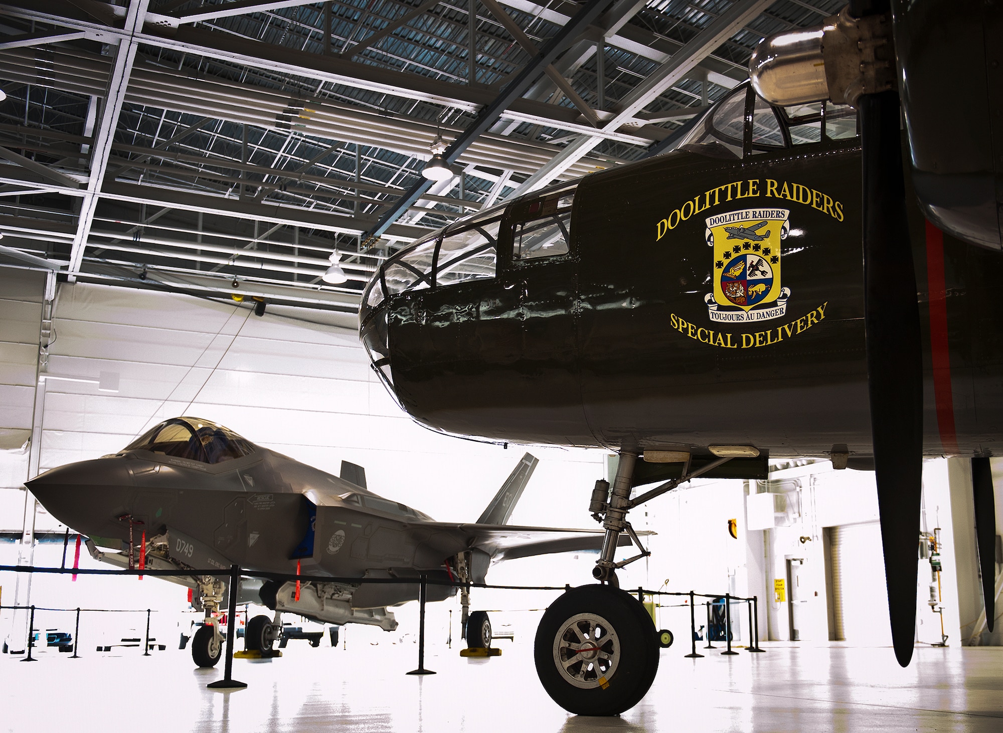 An F-35A Lightning II and the Doolittle Raiders’ B-25 are parked together for the 33rd Fighter Wing’s hangar dedication to Doolittle Raider, Lt. Col. Ed Saylor April 17 at Eglin Air Force Base, Fla.  After unveiling the plaque with his name on it, Saylor spoke about his experiences in the military and with the historic Raiders.  (U.S. Air Force photo/Samuel King Jr.)