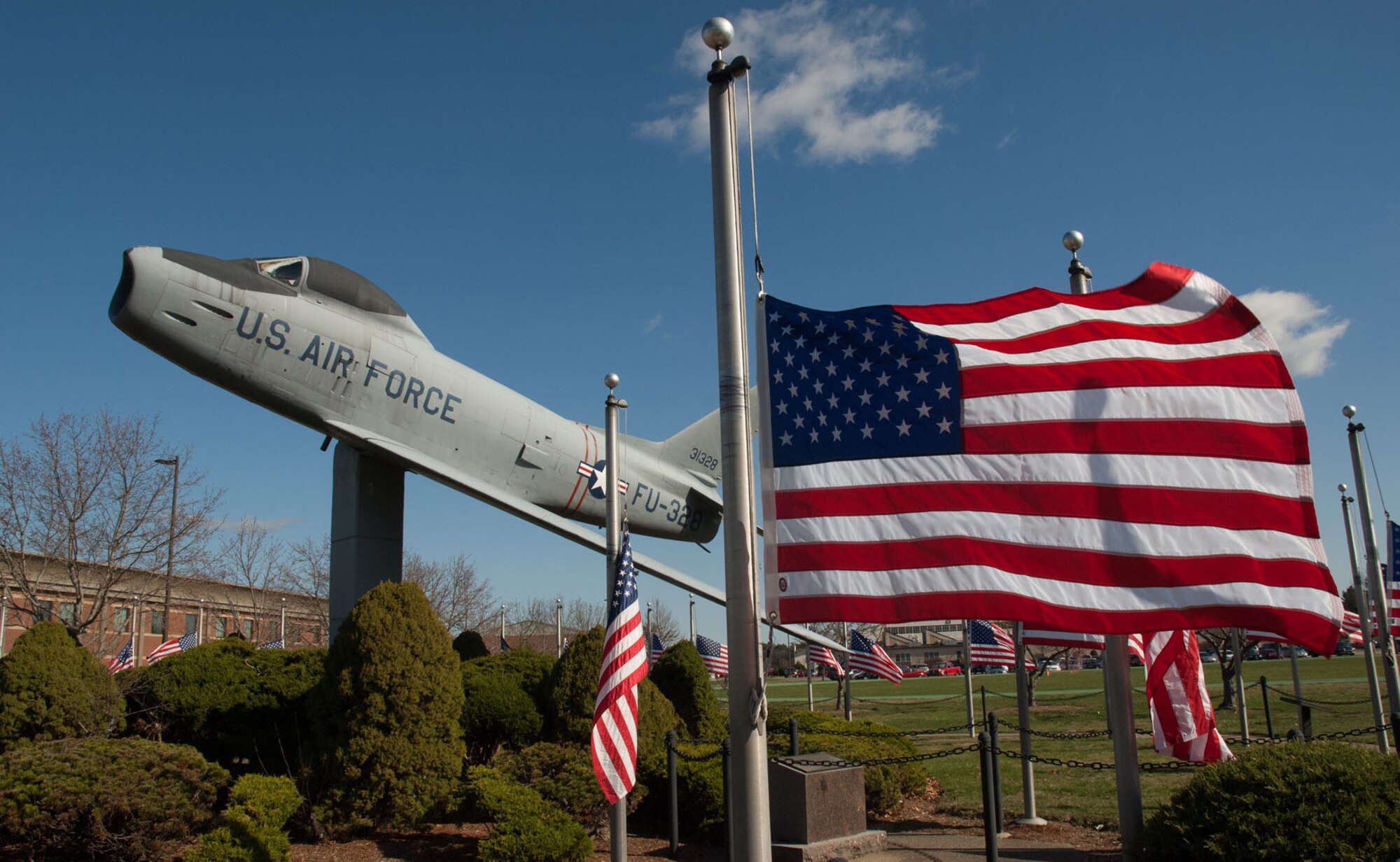 HANSCOM AIR FORCE BASE, Mass. – Flags fly at half-staff around the F-86 static display as a mark of respect for the victims of the Boston Marathon bombing April 17. Personnel who may need help dealing with or processing the tragedy should contact base helping agencies. A list of resources is available at www.hanscom.af.mil/units/support/index.asp. (U.S. Air Force photo by Mark Herlihy)