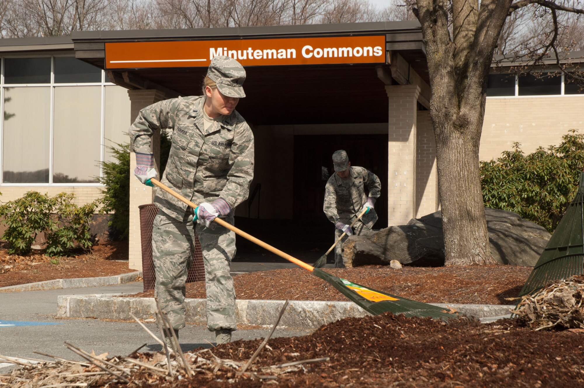 HANSCOM AIR FORCE BASE, Mass. - First Lt. Bethany Parker cleans up the area around the Minuteman Commons April 15 as part of a base beautification day project. Airmen from across the base got out to pick up trash, rake leaves, pull weeds and more. (U.S. Air Force photo by Mark Herlihy)