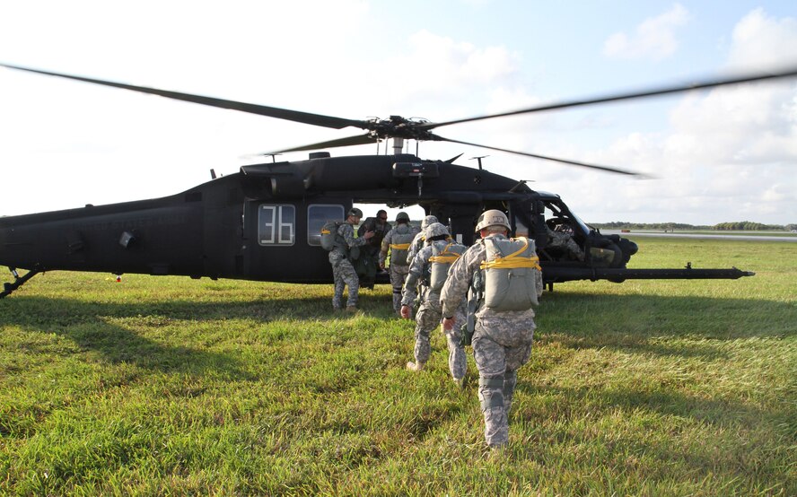 Special Operations Command South Paratroopers board a MH-60 helicopter in order to conduct a rotary-wing airborne operation April 16 at Homestead Air Reserve Base, Fla.  A total of six paratroopers were on board during each airborne lift. (U.S. Army Photo by Sgt. 1st Class Alex Licea, SOCSOUTH Public Affairs/ Released)