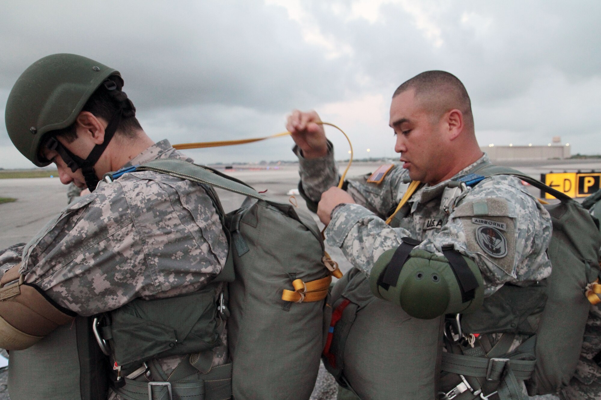 Army Chief Warrant Officer Benjamin Sales, a communications officer for Special Operations Command South, conducts a jumpmaster personnel inspection or JMPI on a fellow paratrooper prior to an airborne operation at Homestead Air Reserve Base, Fla., April 16.  A JMPI is done in order to ensure the safety of each jumper as they exit the aircraft. This operation allows airborne-qualified personnel assigned to SOCSOUTH to maintain current airborne proficiency and mission readiness in response to any contingency response force in the command's area of responsibility, which spans from the Caribbean, Central and South America. (U.S. Army photo by Sgt. 1st Class Alex Licea, SOCSOUTH Public Affairs/Released)