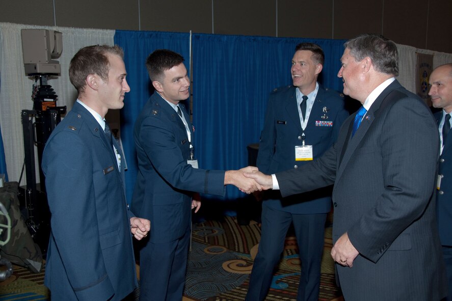 LEDYARD, Conn. – In this 2009 photo, Secretary of the Air Force Michael Donley chats with officers from the former Electronic Systems Center at Hanscom Air Force Base, Mass., while touring the display area at the Air Force C2ISR Symposium. Donley will present an “all call” during his upcoming visit to the base April 25. (U.S. Air Force photo by Rick Berry)