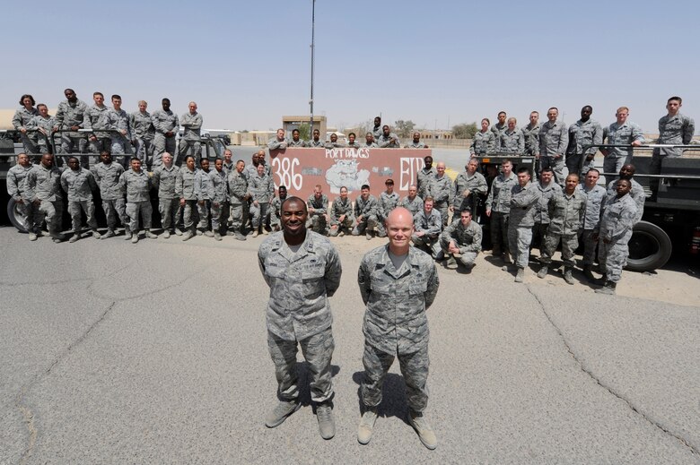 Senior Master Sgt. Paul Carter, 386th Expeditionary Logistics Readiness Squadron, Port Superintendent (right) with the “Port Dawgs” at the 386th Air Expeditionary Wing, Southwest Asia Apr 15, 2013. Carter is one of 48 Airmen from Dobbins Air Reserve Base, Ga. deployed to ‘The Rock’ where they make up roughly 60 percent of the 85 member port team. (U.S. Air Force photo by Staff Sgt. Austin Knox)