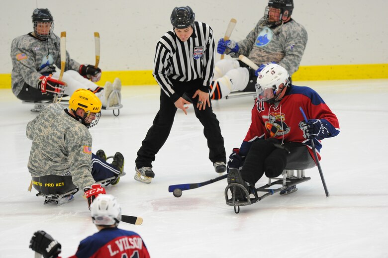 Wounded Warriors playing sled hockey. 