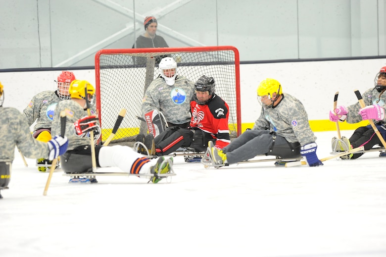 Wounded Warriors playing sled hockey. 