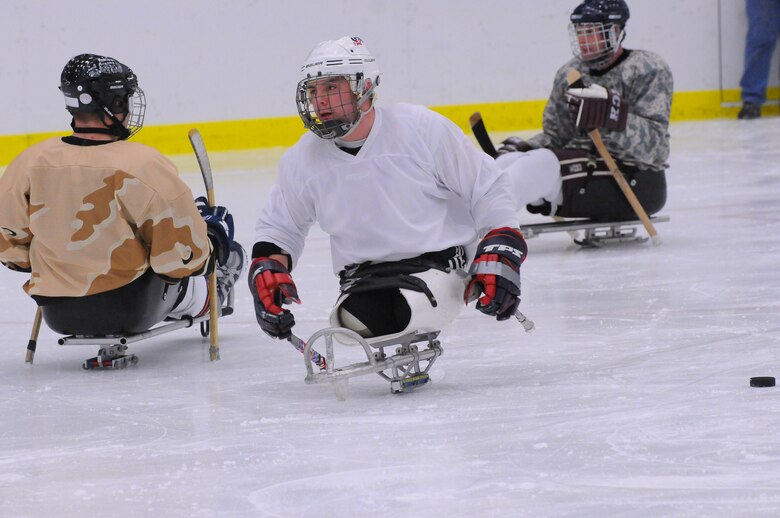 Wounded Warriors playing sled hockey. 